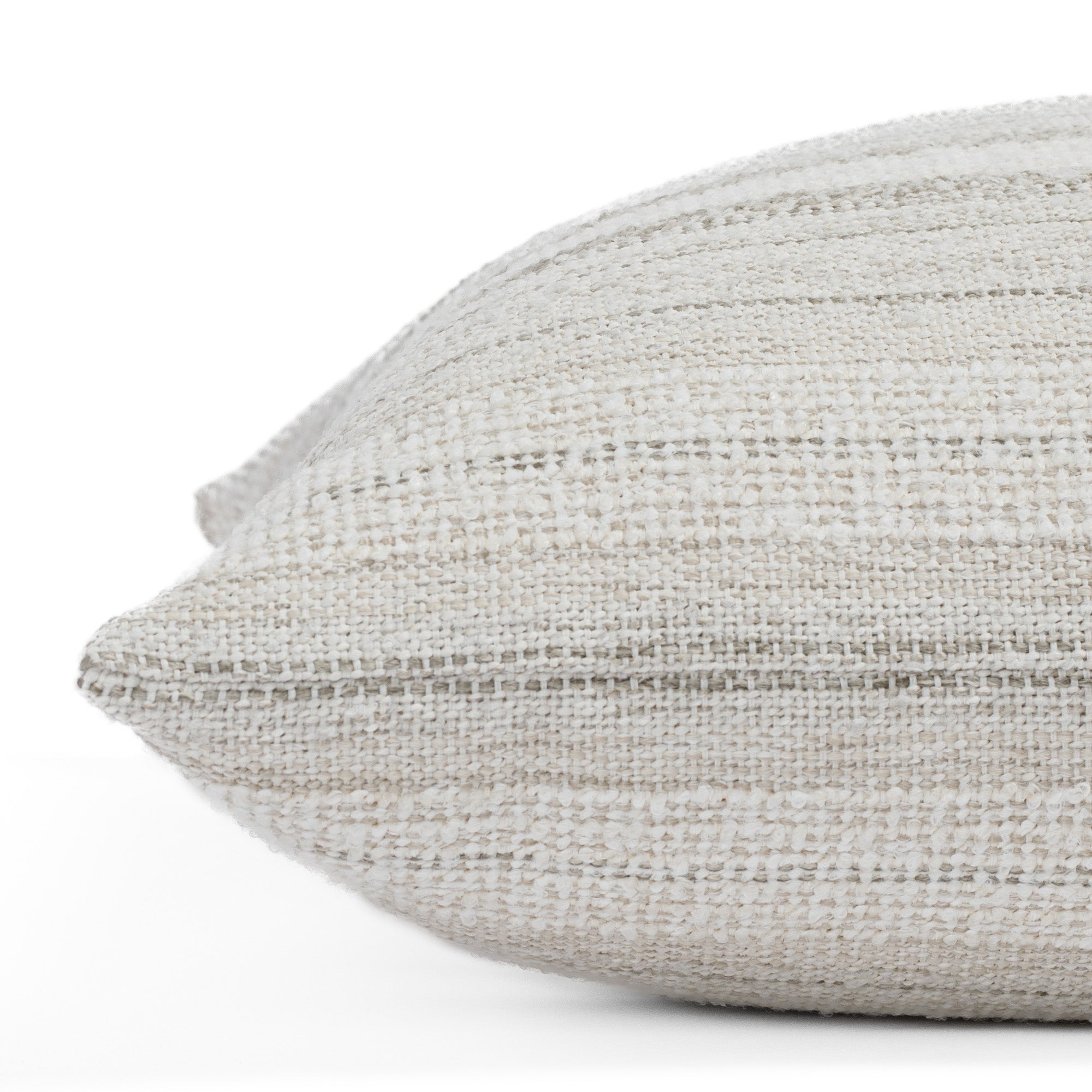 Acadia Salt, a soft white and greige striped throw pillow from Tonic Living: close up side view.