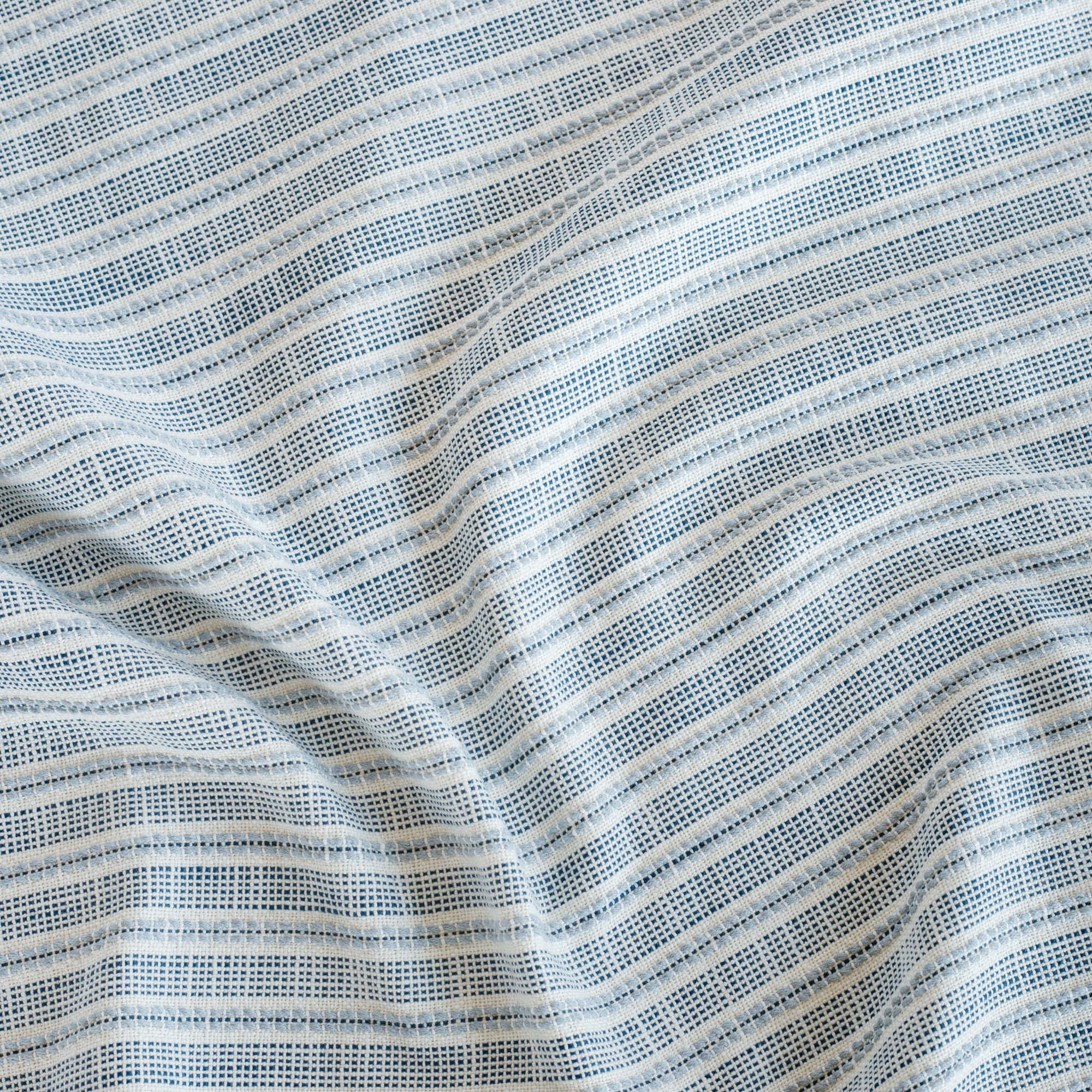  a white, indigo and chambray blue stripe outdoor performance fabric