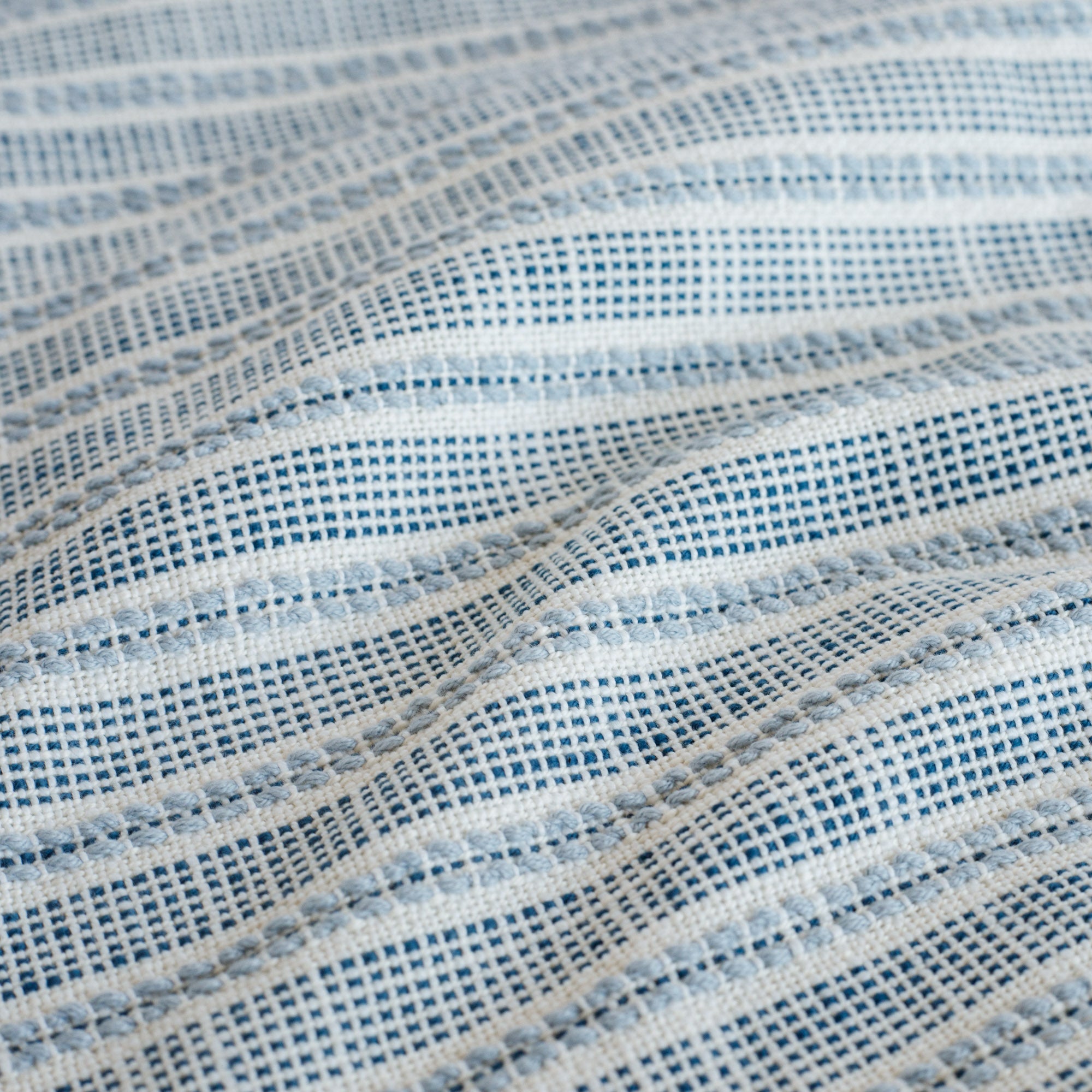   white, indigo and chambray blue stripe upholstery fabric : close up view