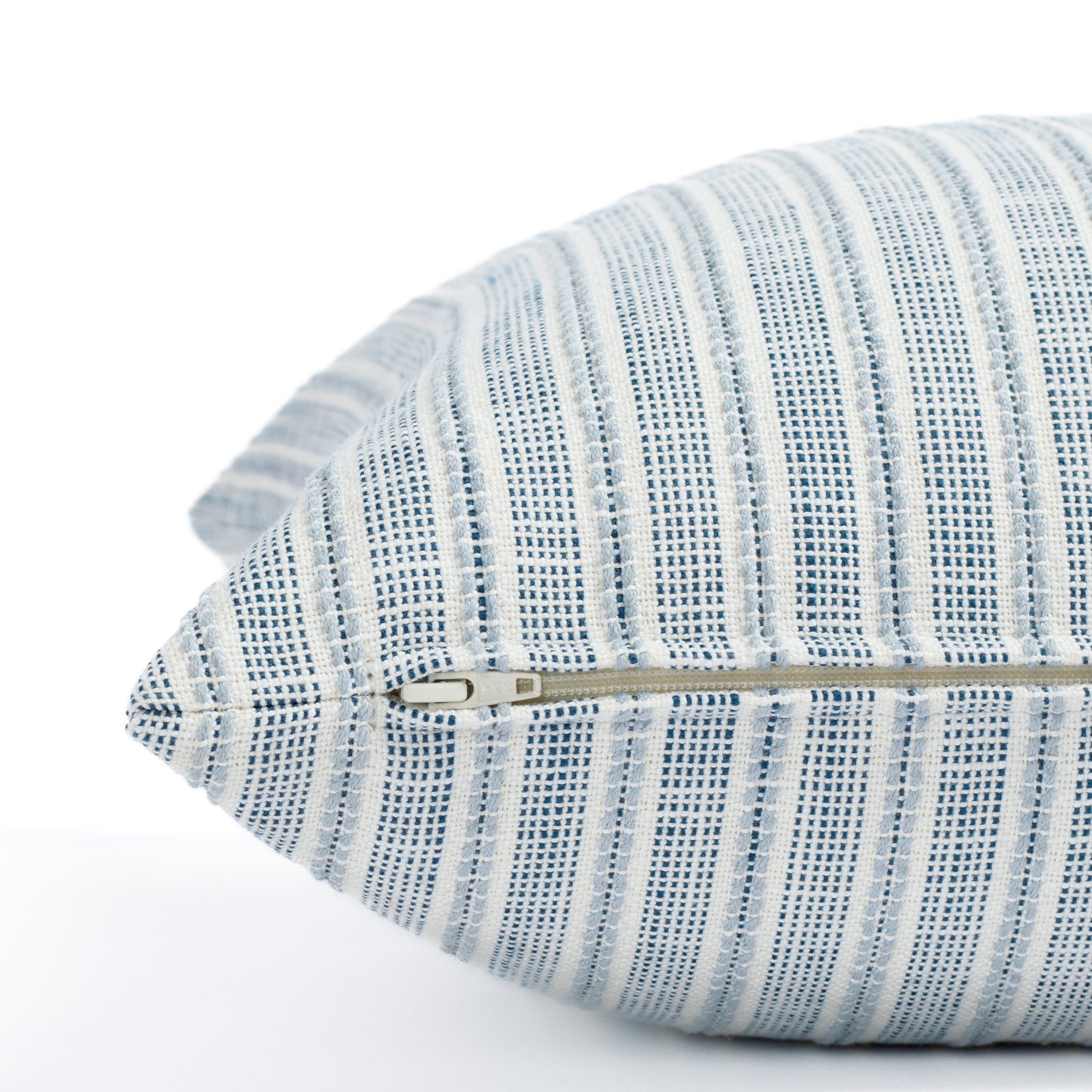 a blue and white stripe outdoor throw pillow : close up zipper view