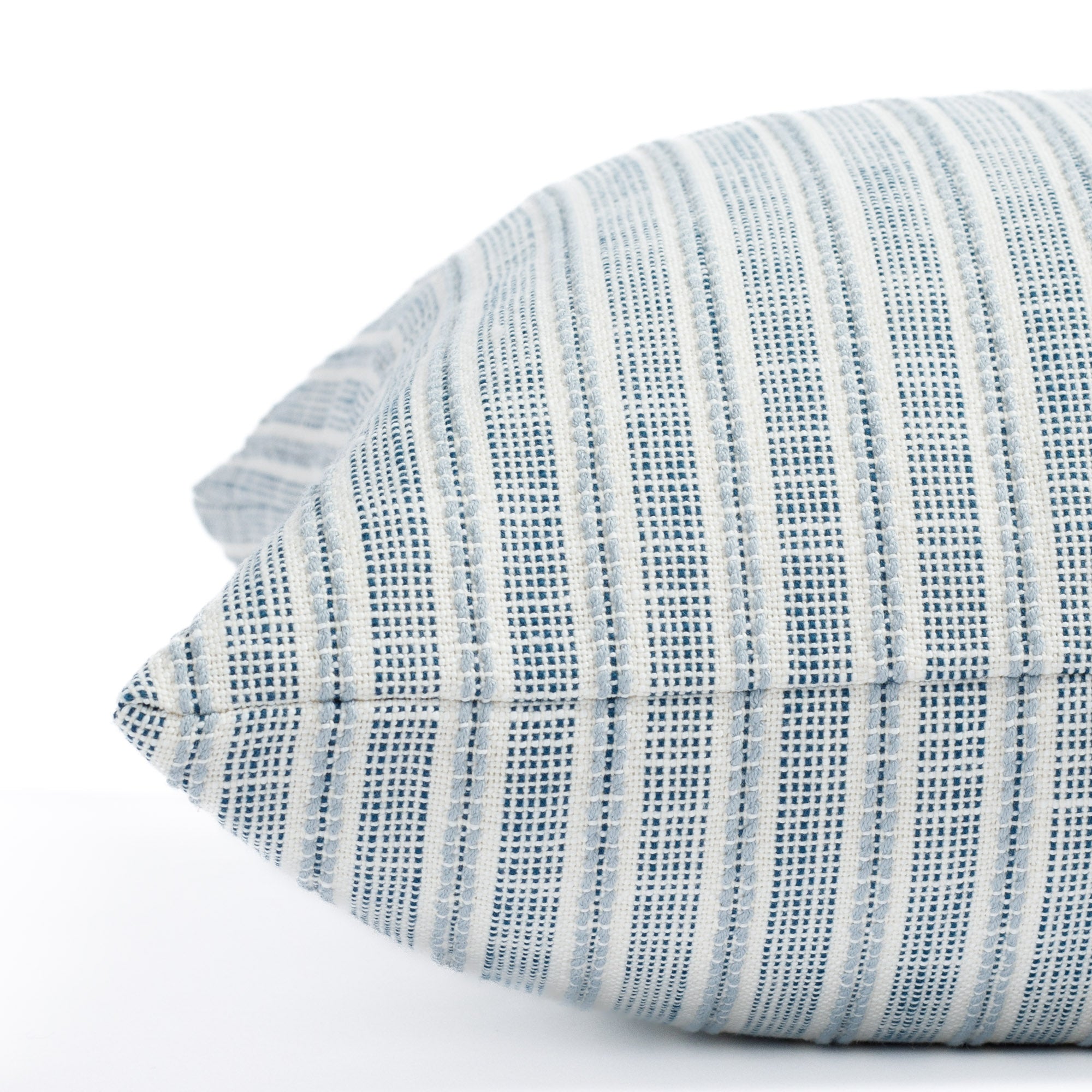 a blue and white stripe outdoor throw pillow : close up side view