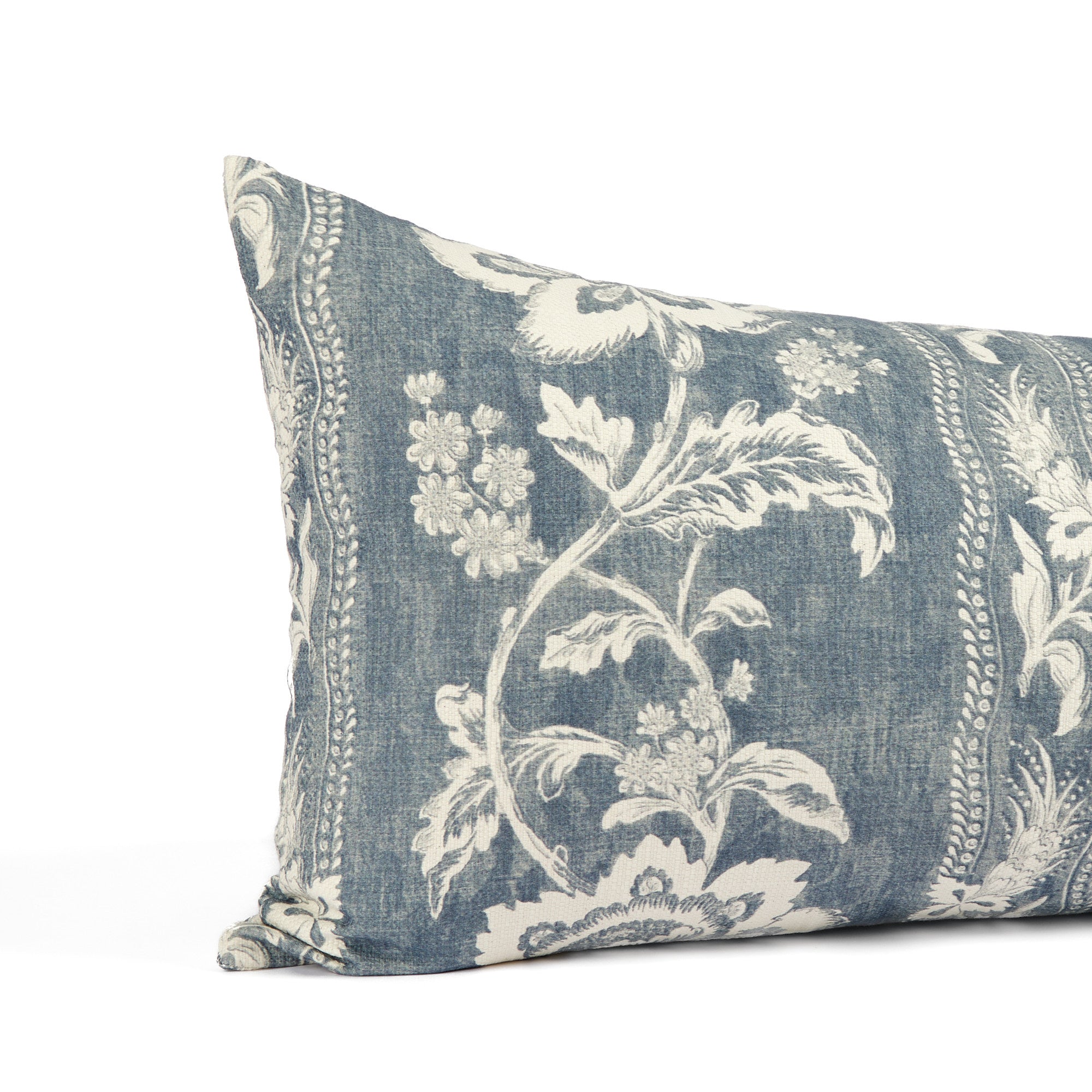 Close up of Tonic Living Ashford bed bolster showing scrolling floral vine detail in chambray blue and white.
