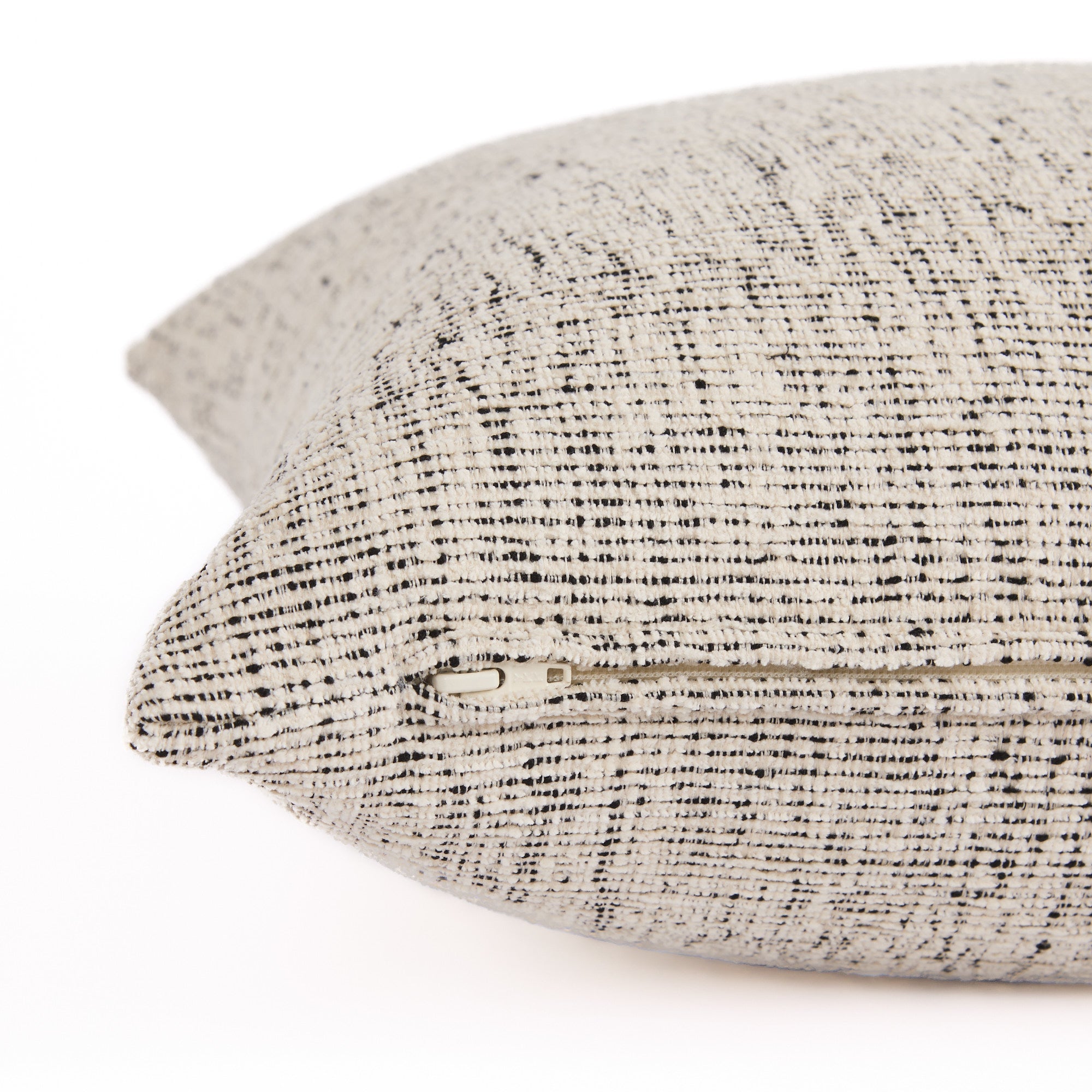 Side view of Atlas 22x22 pillow with hidden zipper, off-white and black indoor-outdoor cushion by Tonic Living.