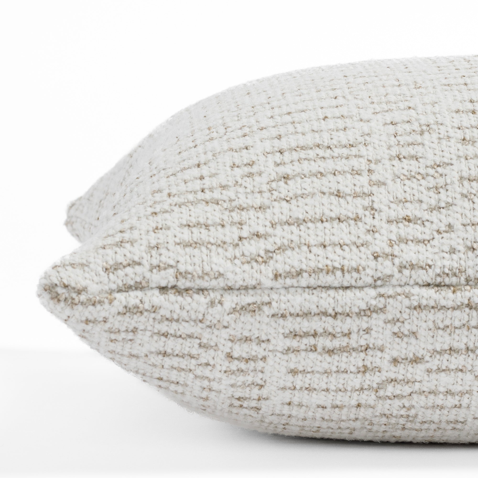 A neutral textured designer throw pillow from Tonic Living: close up side view.