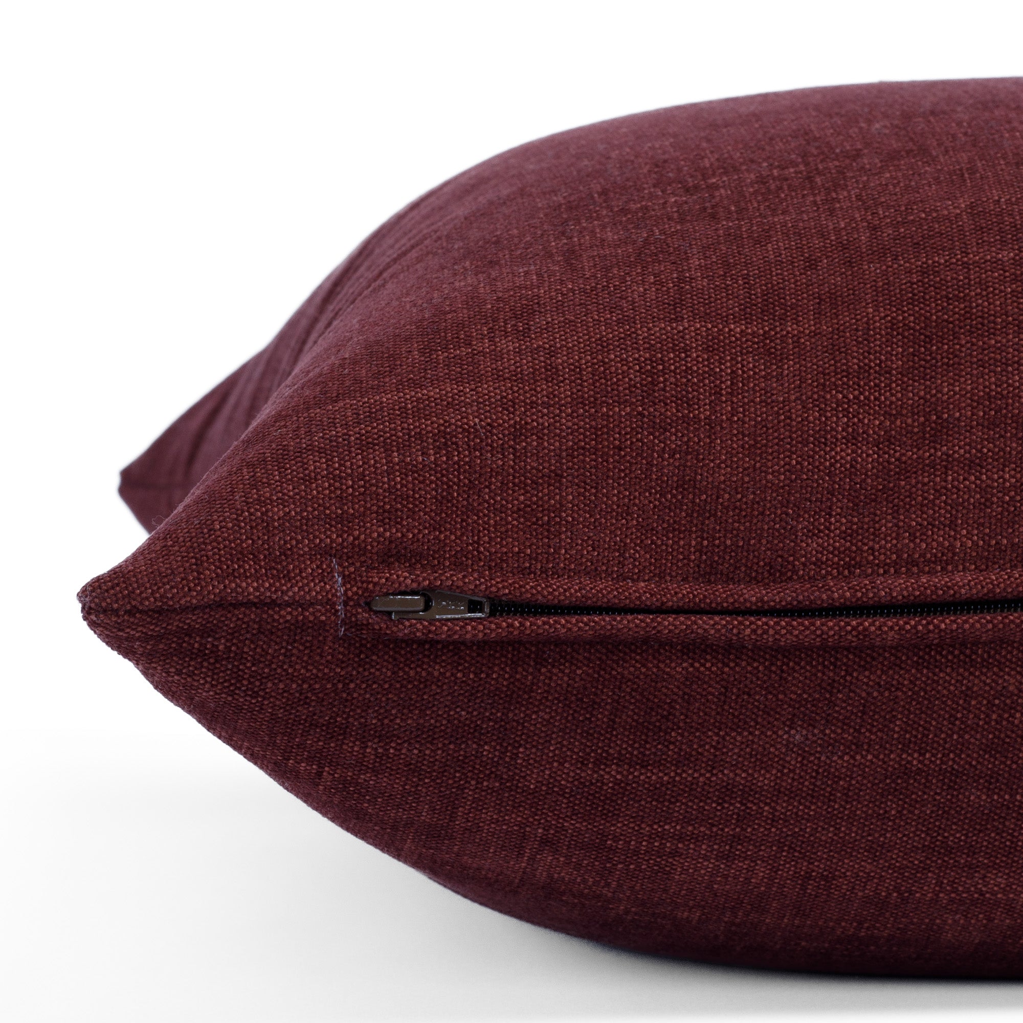 Zipper detail of Bedford Merlot toss pillow, Tonic Living chenille fabric in rich burgundy tone.