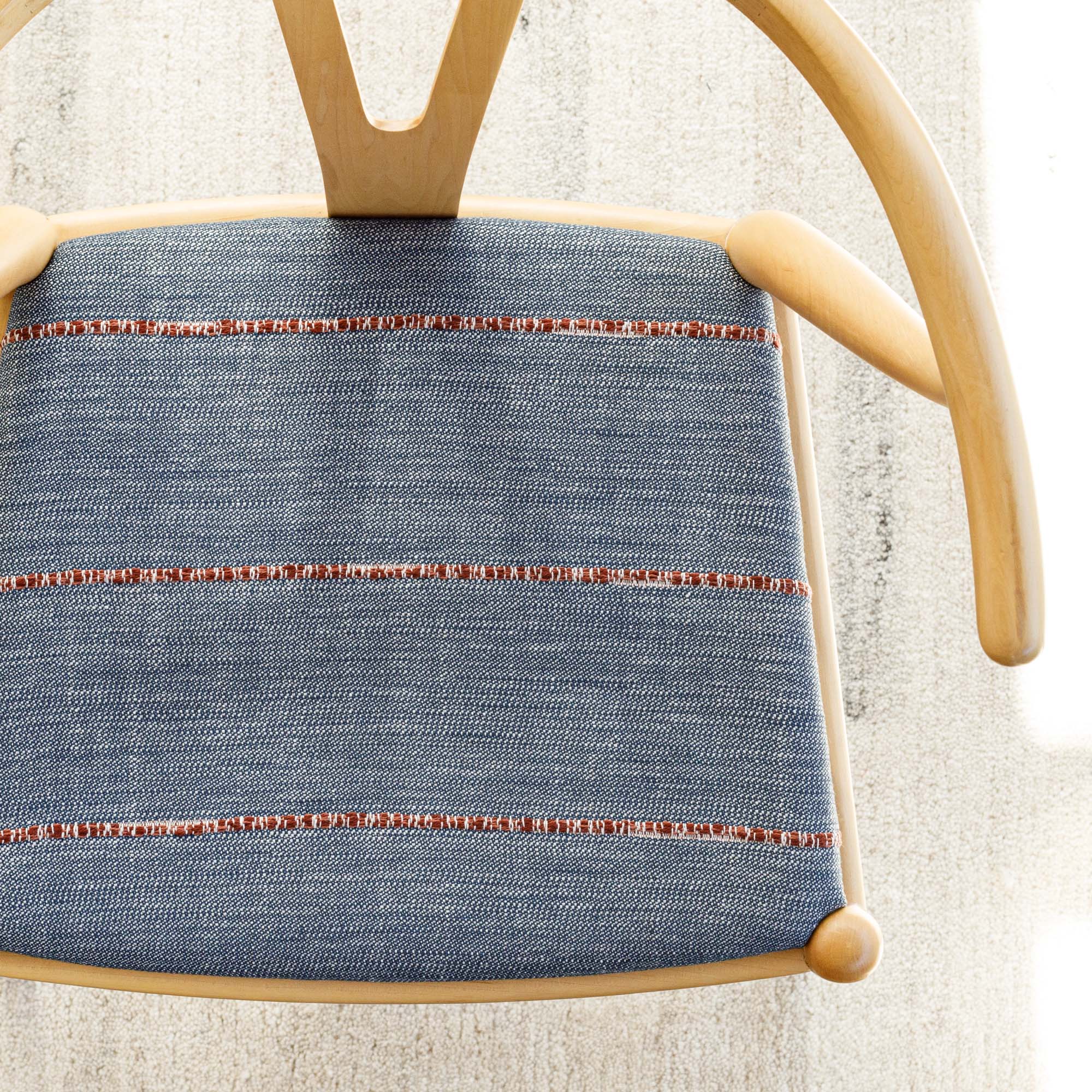 a navy blue with rusty red stripe upholstered chair seat