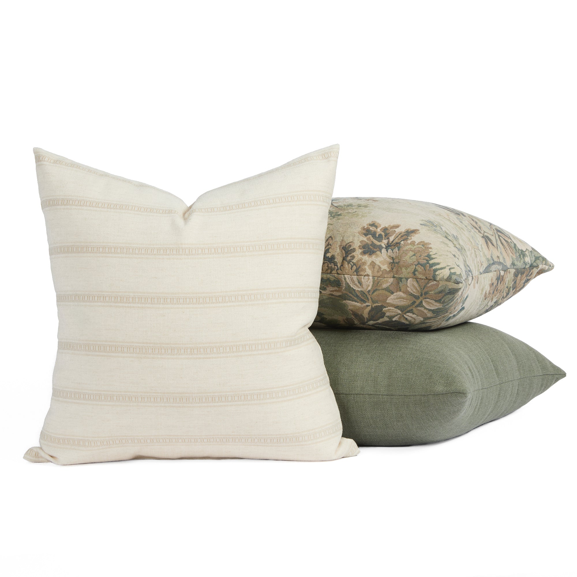 Tonic Living Brunswick cream pillow centered in front of two green-toned cushions for a layered look.