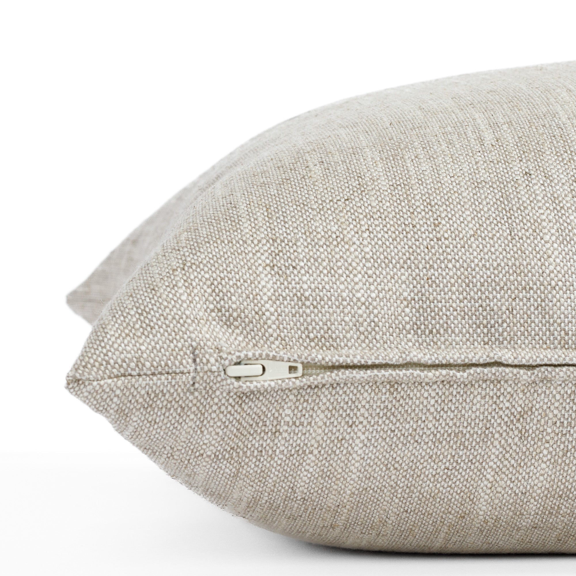 a beige linen blend throw pillow : close up zipper view