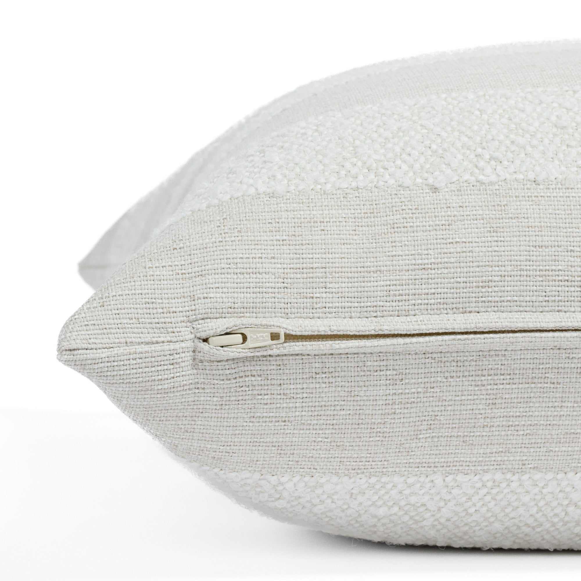 Cabana Stripe Salt 22x22 pillow, a white and beige striped indoor/outdoor pillow from Tonic Living: close-up zipper view.
