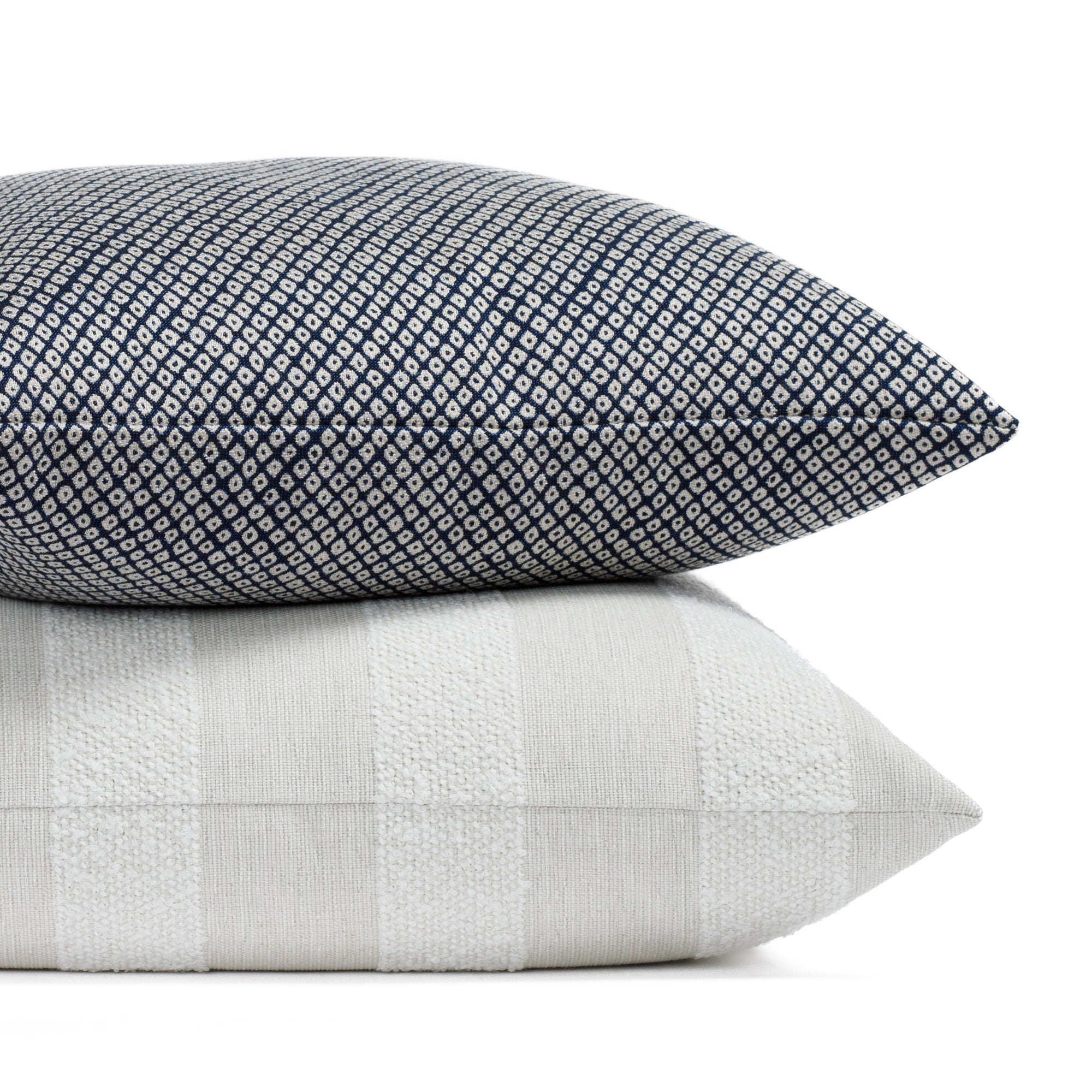 Two navy and neutral toned indoor/outdoor toss pillows from Tonic Living.