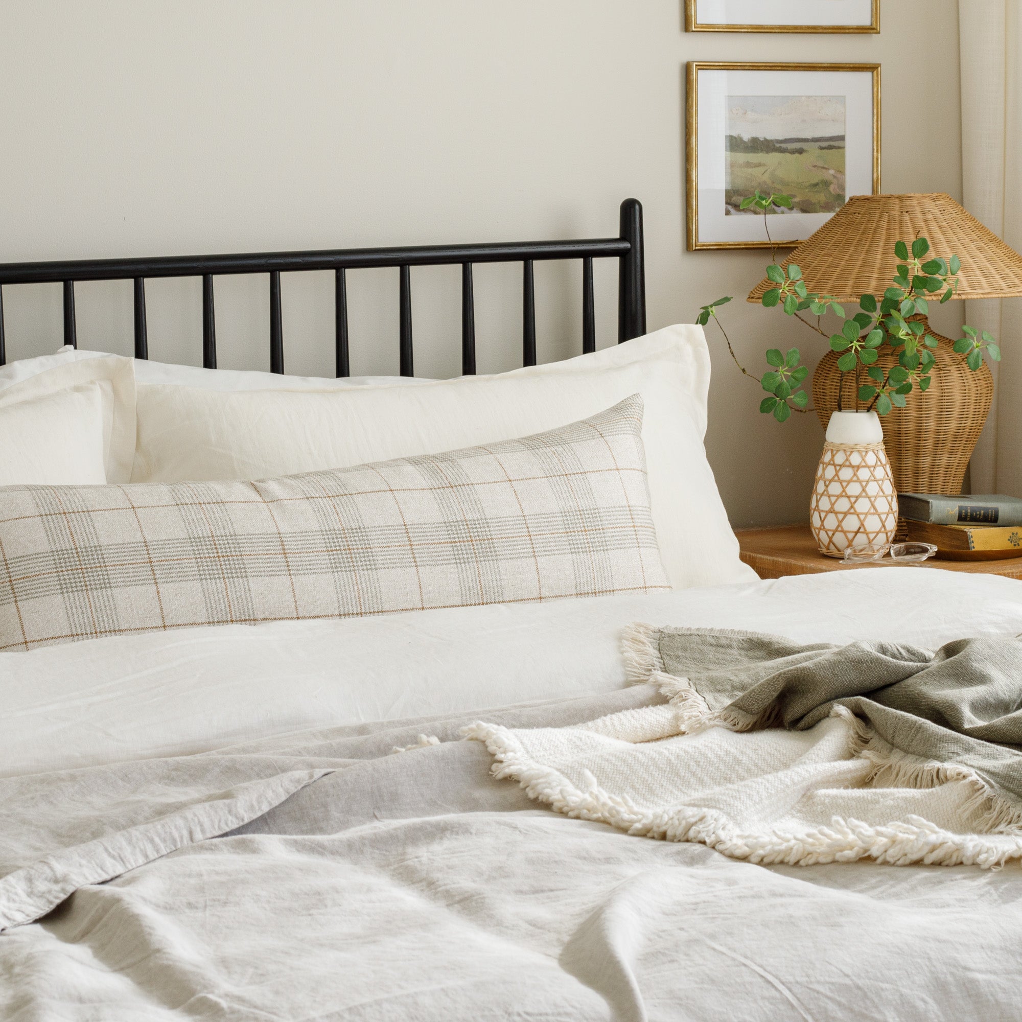 Cabot Plaid Sage 16x42 Bolster Pillow, a soft beige, green, and brown plaid pillow from Tonic Living, styled on a bed.