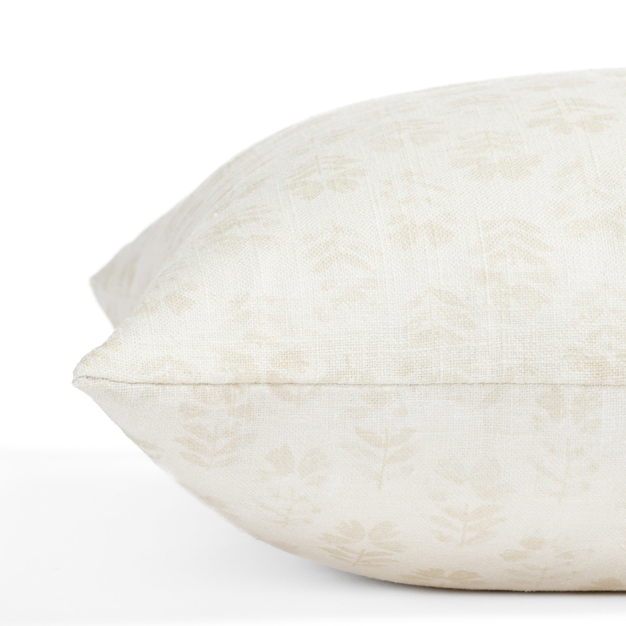 a subtle cream tonal floral block print pillow : close up side view