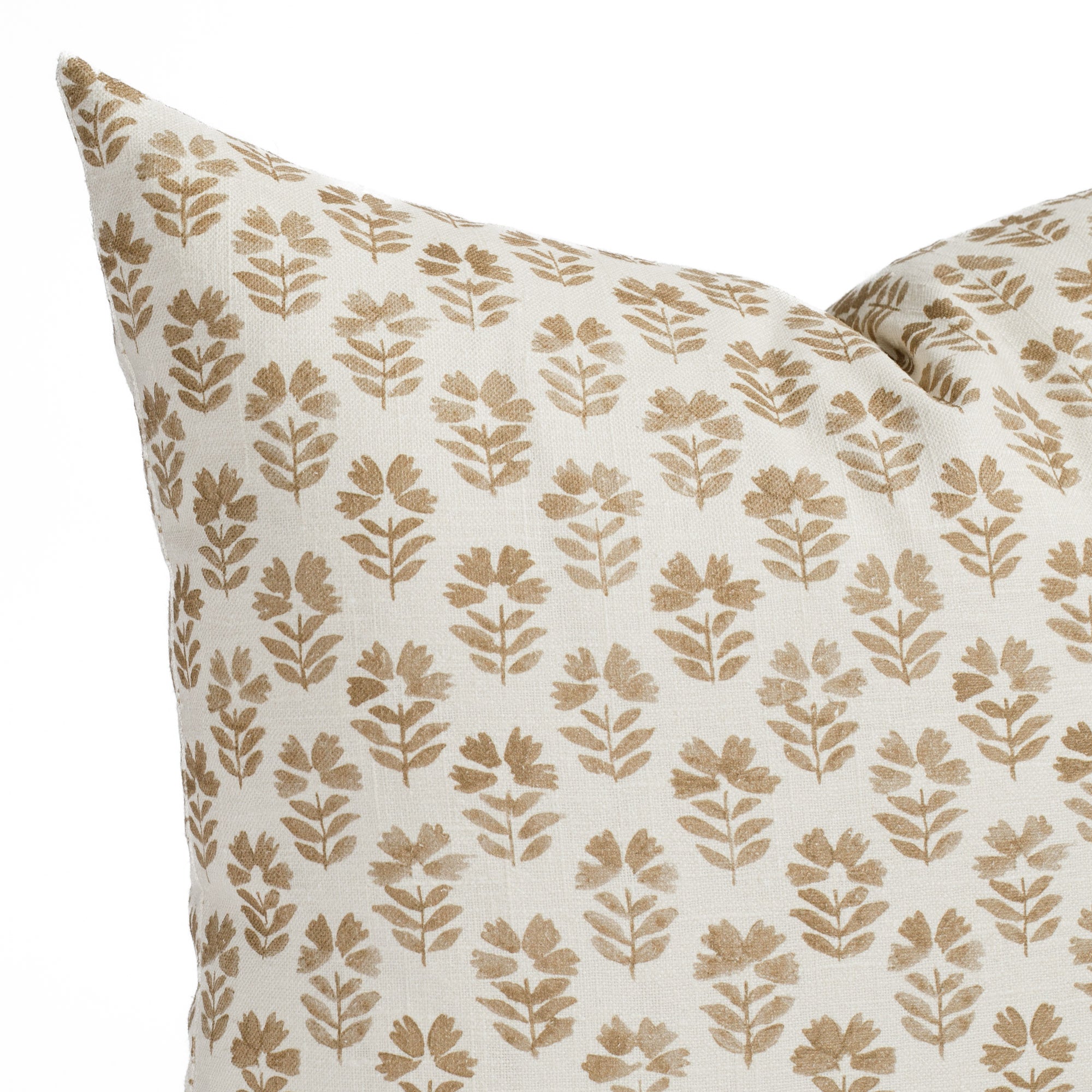 a brown and cream floral block print pillow: close up view