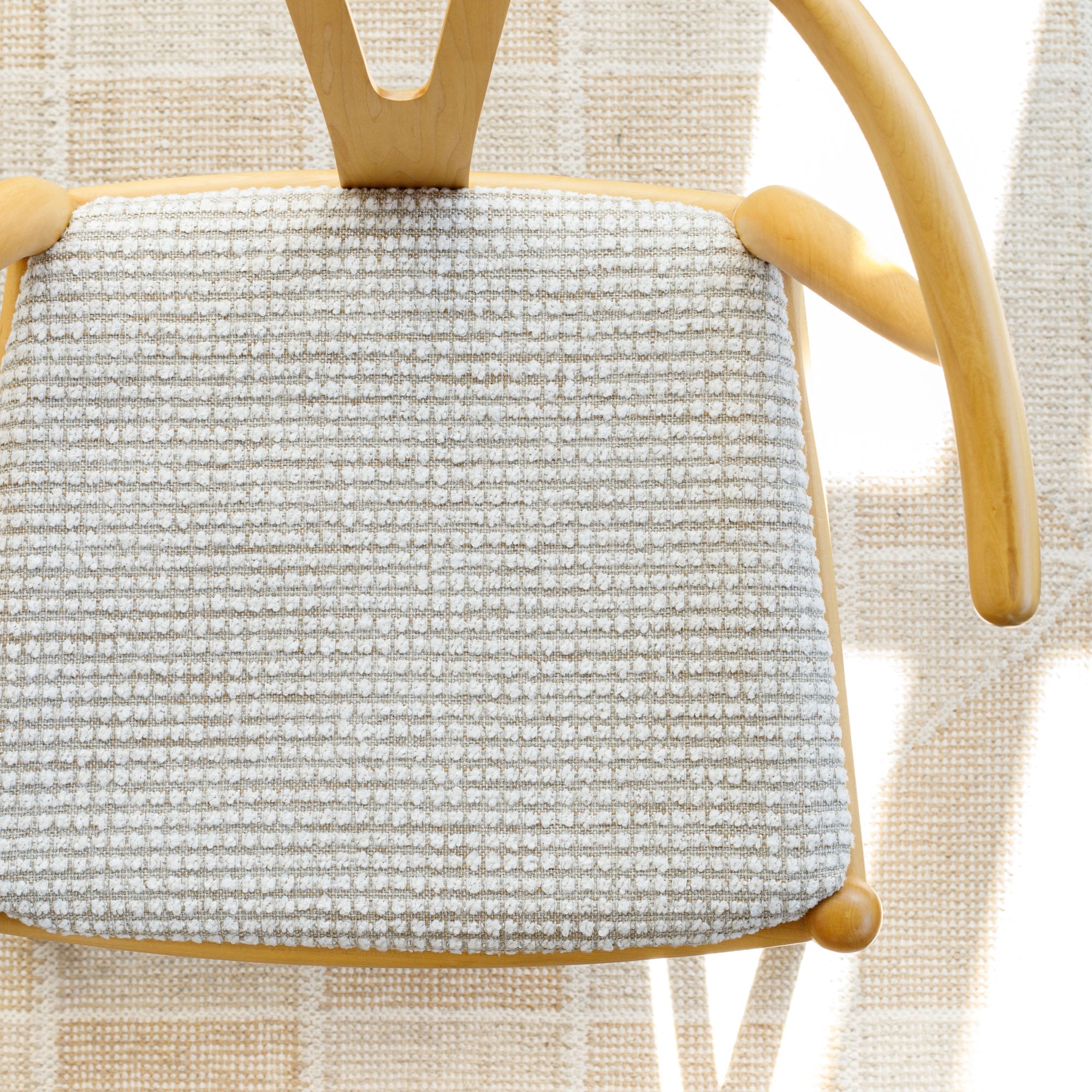 a greige and white nubby textured upholstered chair seat