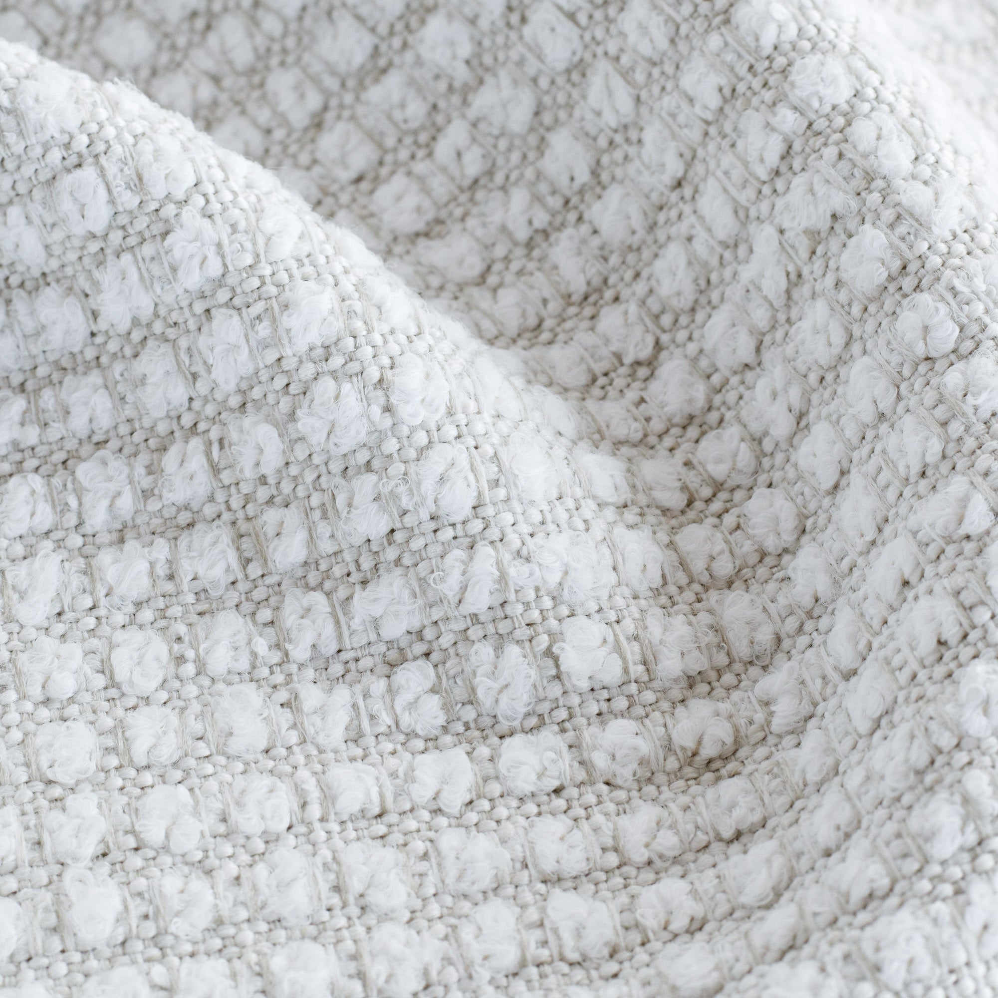 a creamy white nubby grid pattern high performance upholstery fabric : close up view