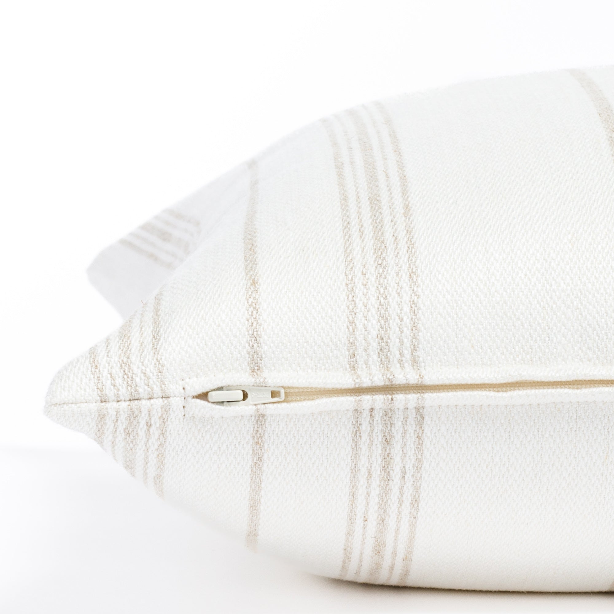 a flax beige and white vertical stripe throw pillow : zipper detail