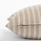 a light brown and oatmeal beige vertical stripe throw pillow : close up zipper view