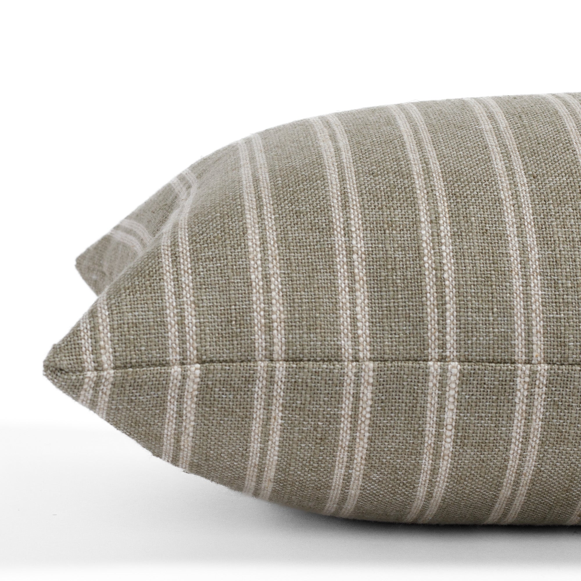 Detailed side close-up of the Conway Stripe Sage 12x24 lumbar pillow from Tonic Living, emphasizing the vertical stripe pattern and soft, organic colour mix of sage green and oatmeal.