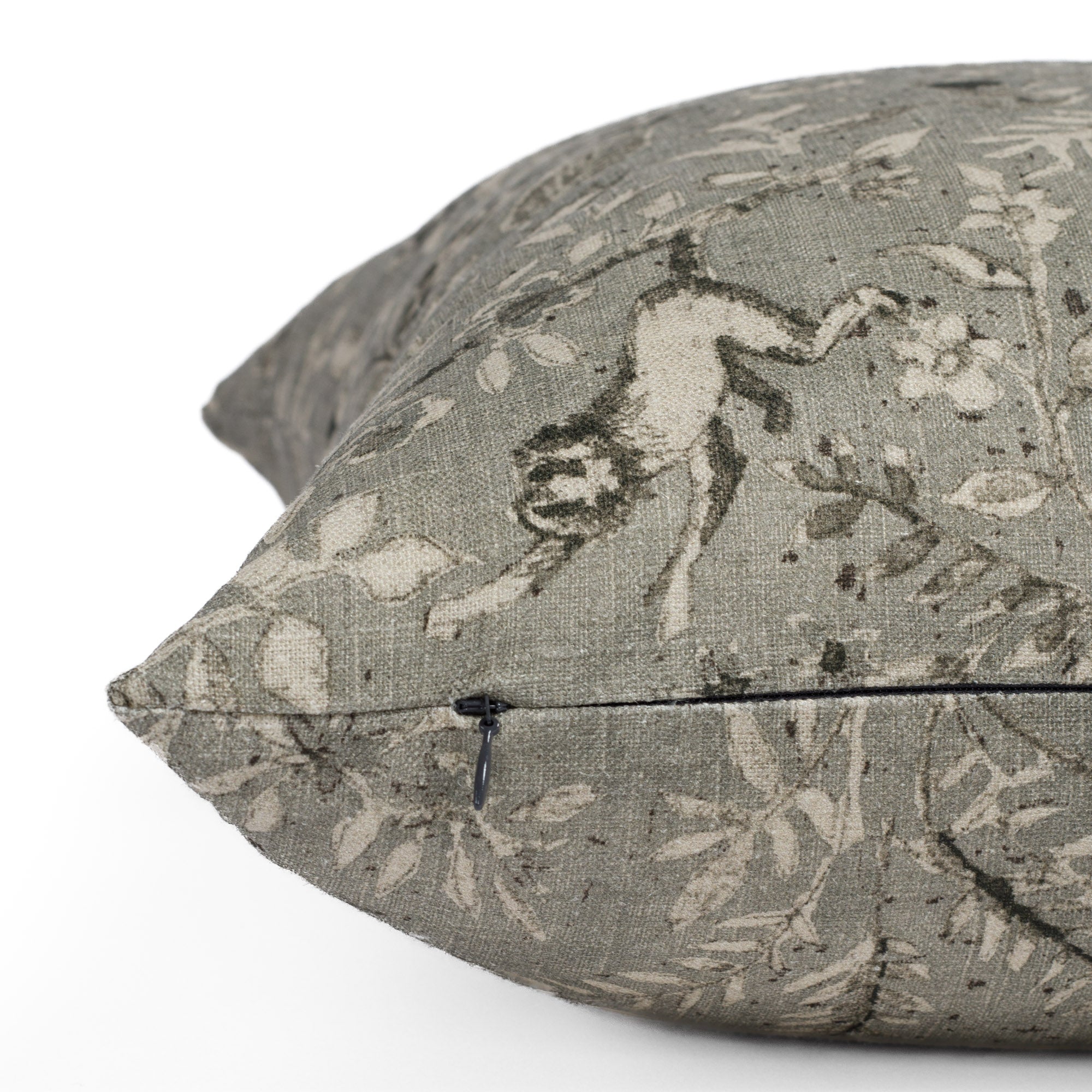 Tonic Living Cyprus smokey blue-grey toss pillow in linen-blend, showing side zipper detail and botanical animal pattern
