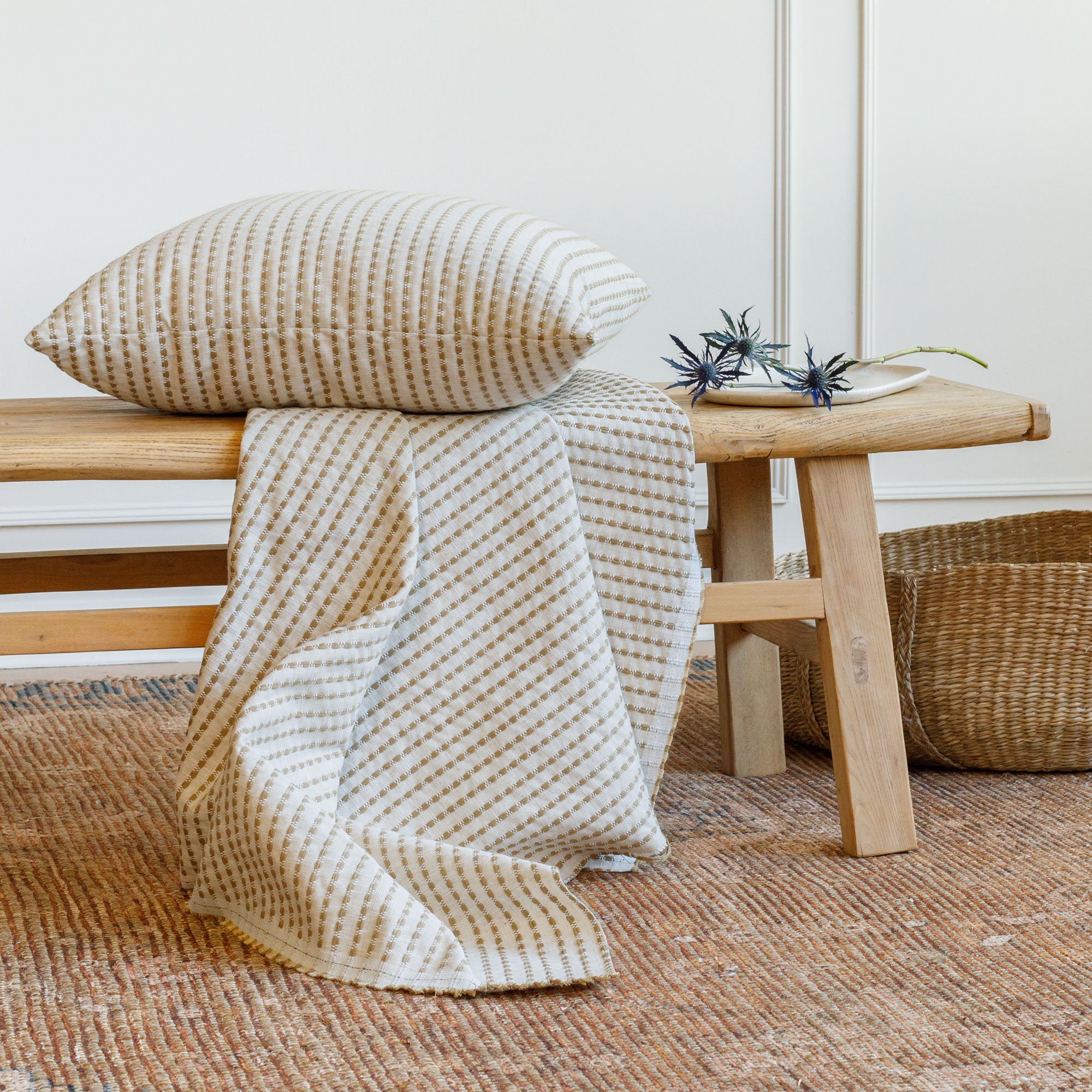 Dash 22x22 pillow in ochre styled with matching Dash upholstery fabric on a bench, Tonic Living.