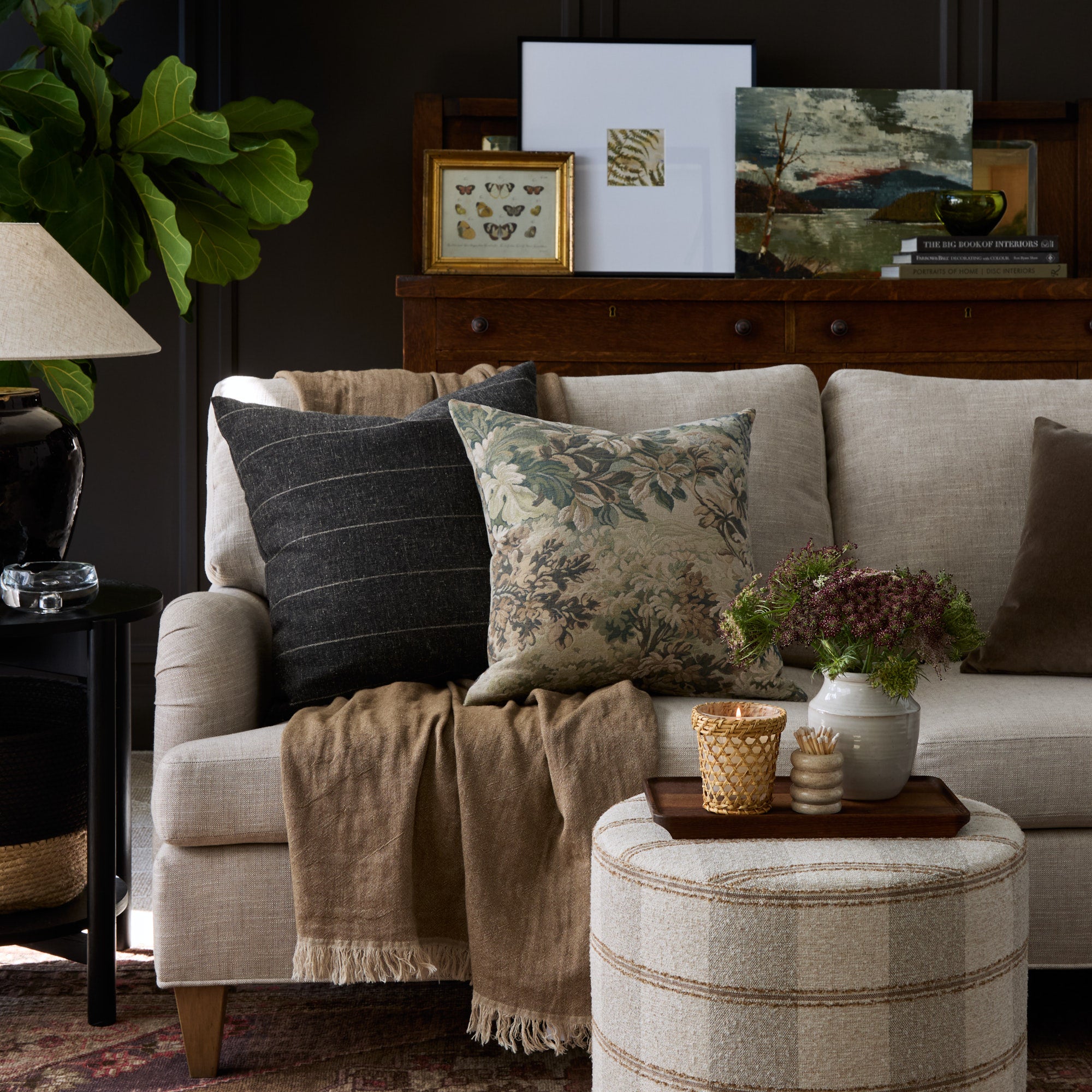 Rich patterned toss cushions from Tonic Living - styled in a moody living room.