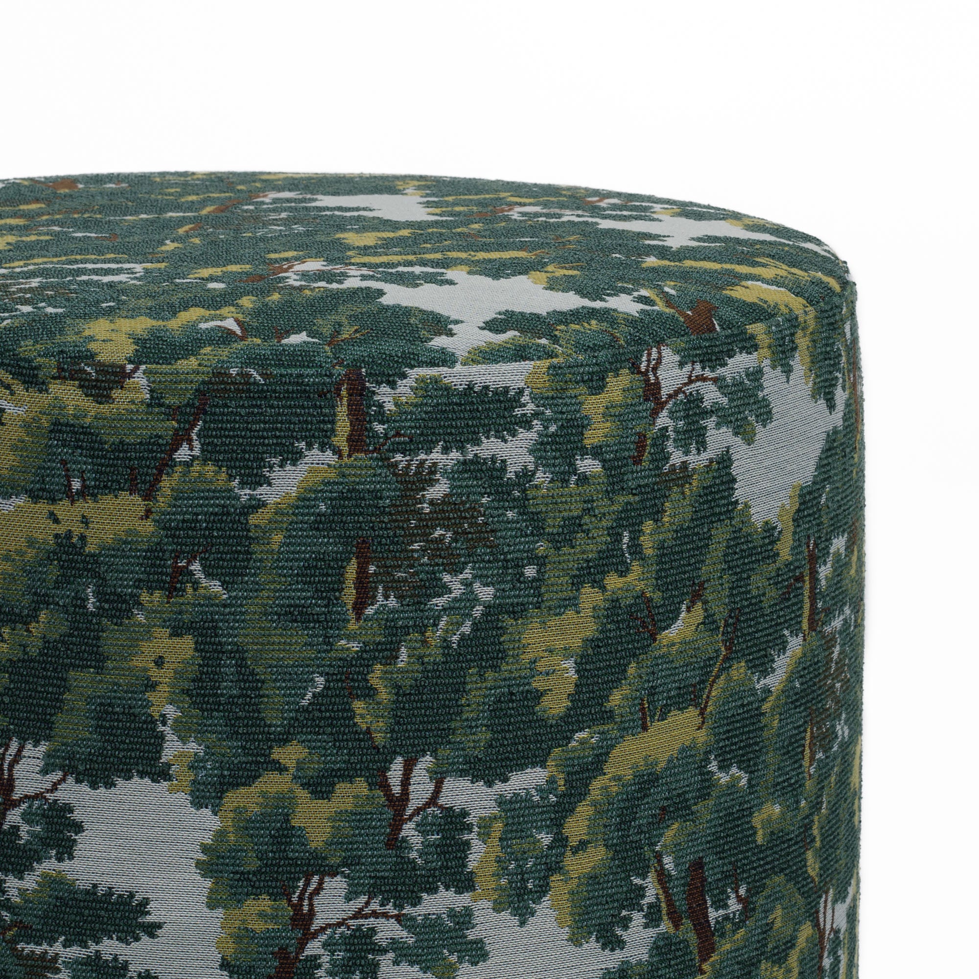 Close-up of the Elora Forest Green ottoman from Tonic Living, showing a detailed forest motif in green, brown, and light blue tones.