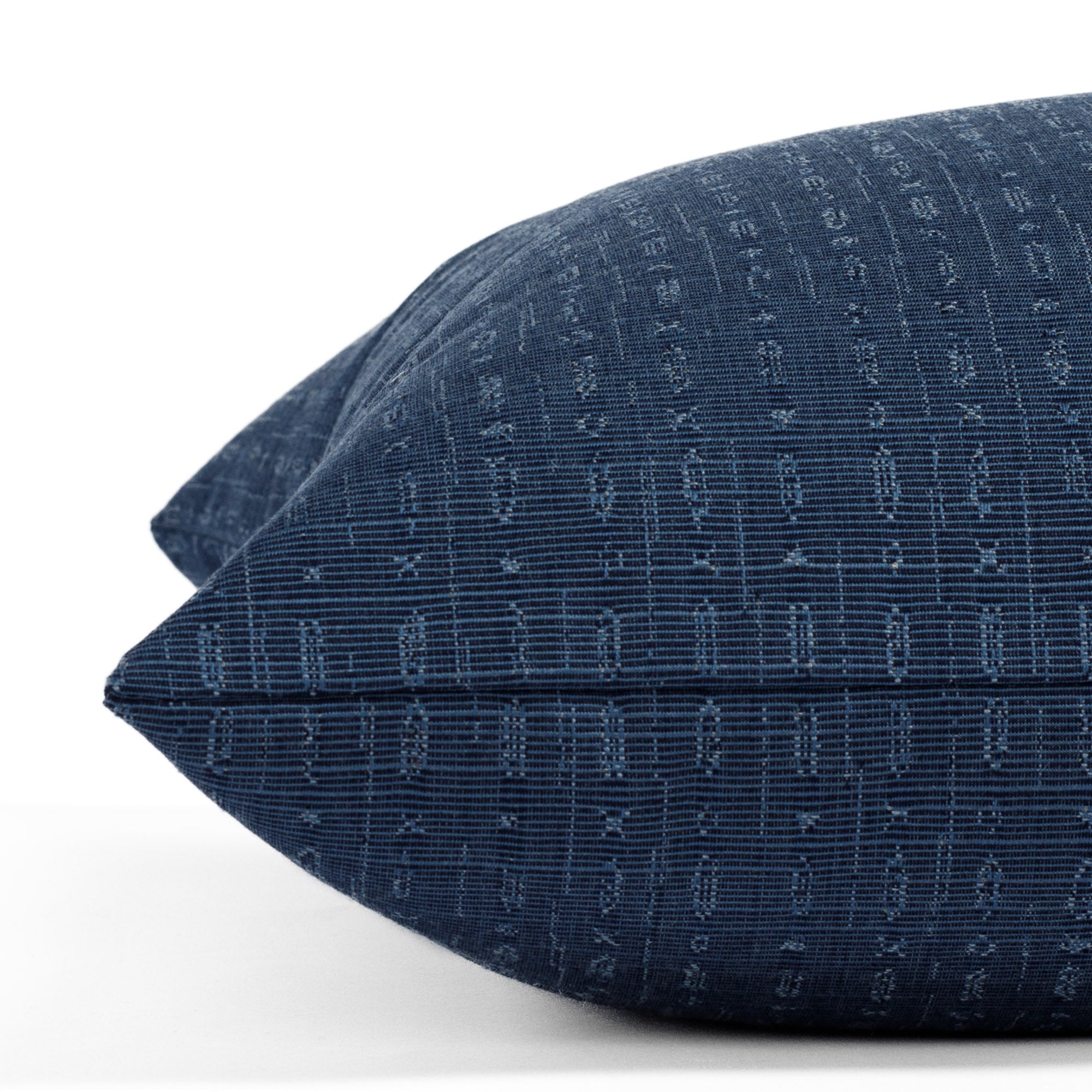 Embrace Indigo, a navy blue 22x22 pillow from Tonic Living, with a subtle abstract geometric design: close up view.