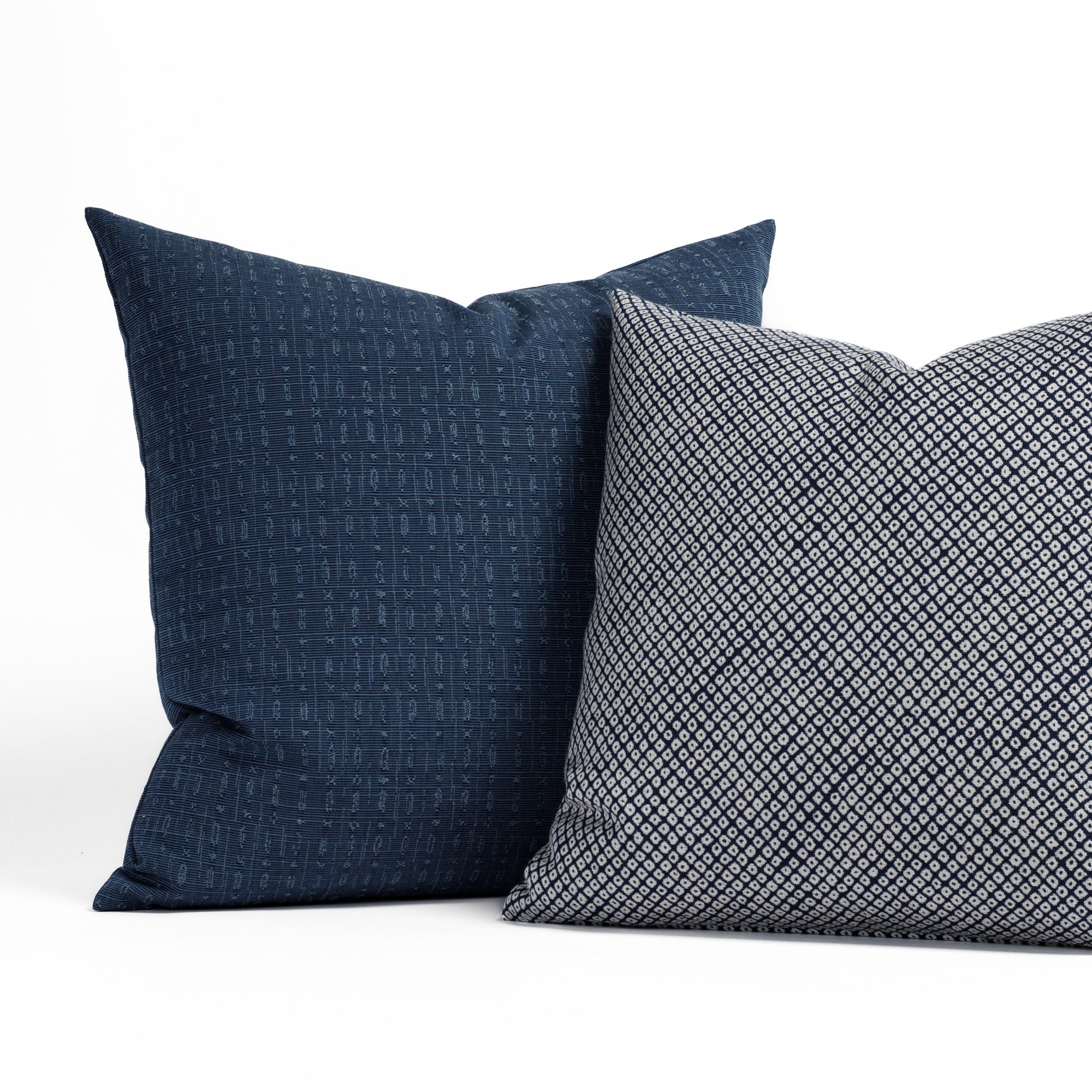 Two navy patterned indoor/outdoor pillows from Tonic Living.