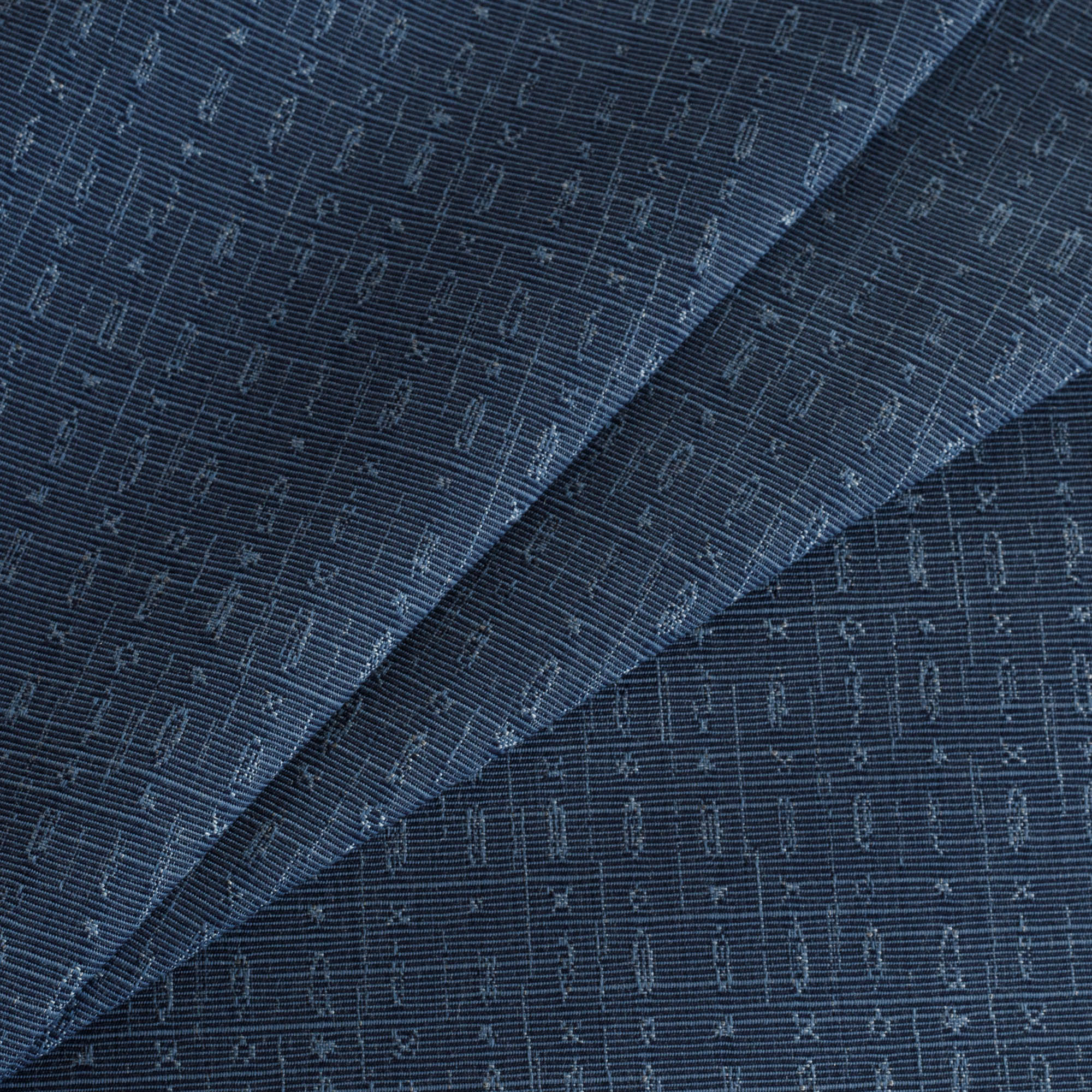 Embrace Indigo Sunbrella Outdoor Fabric from Tonic Living, a navy tone-on-tone upholstery fabric featuring an abstract geometric design.