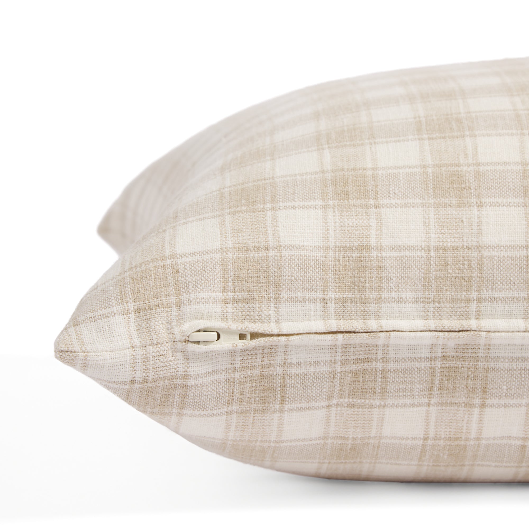 Side zipper detail of Tonic Living Emmett Plaid 20x20 pillow in soft flax beige and white plaid.