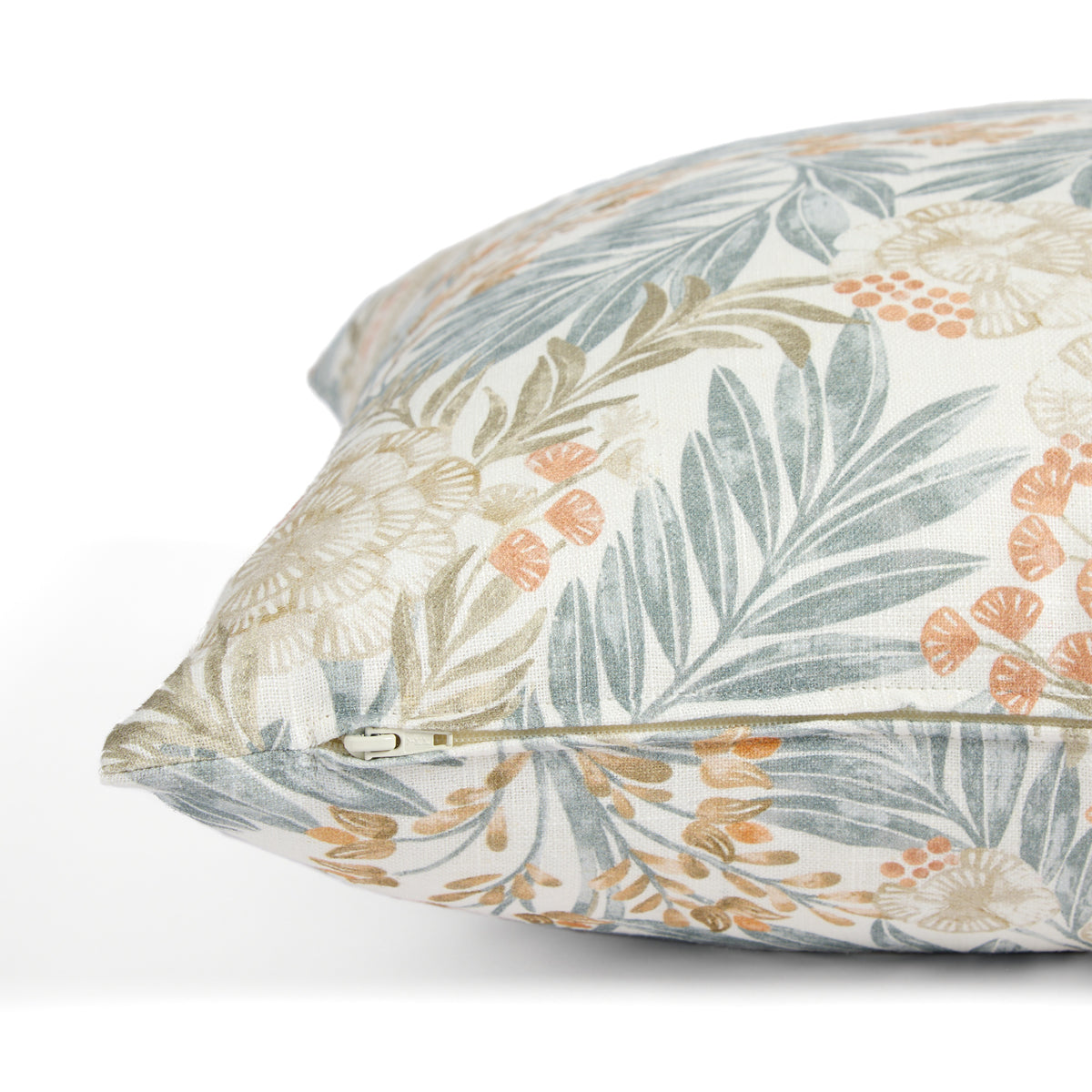 Side zipper detail of Tonic Living Fable 20x20 throw pillow featuring a blue, terracotta, and light brown botanical pattern.