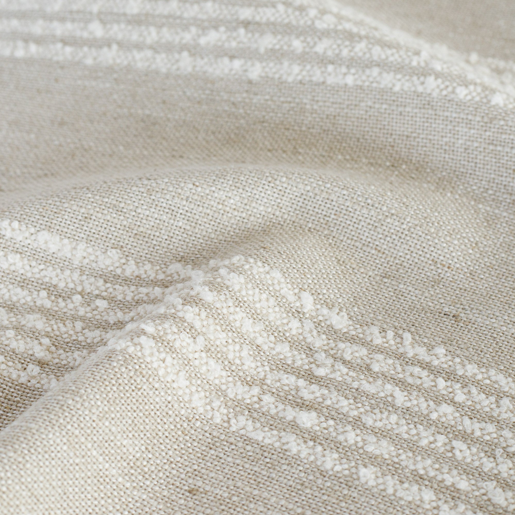 a cream and off white loopy stripe fabric : close up view