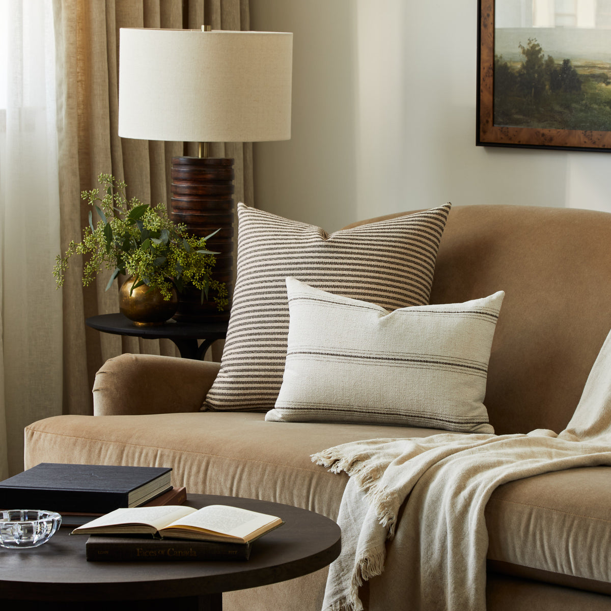 Tonic Living Crosby Stripe Truffle decorative pillow styled on a sofa with a neutral striped lumbar cushion.