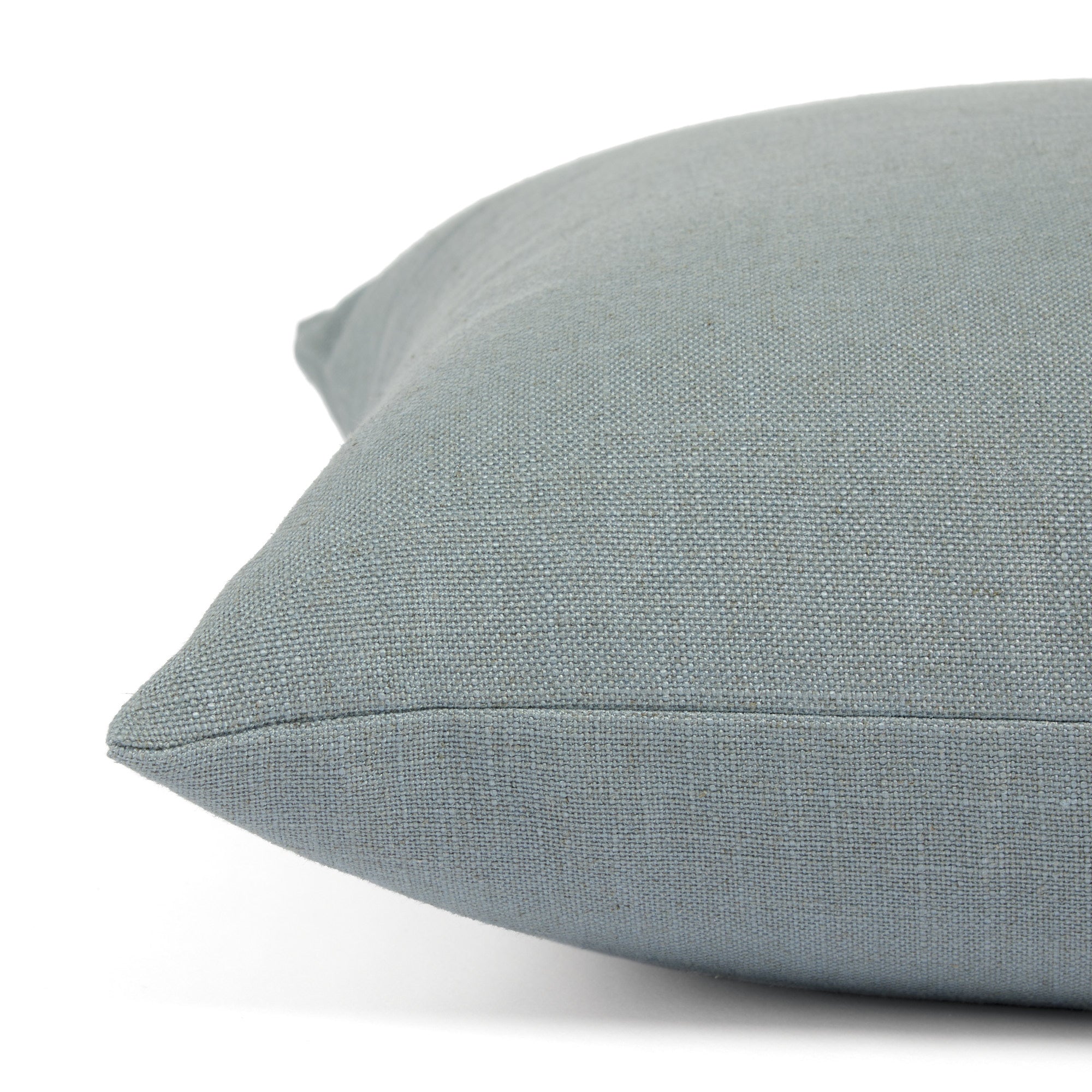Side view of Tonic Living Hampton Chambray decorative pillow highlighting its light blue Belgian linen look.