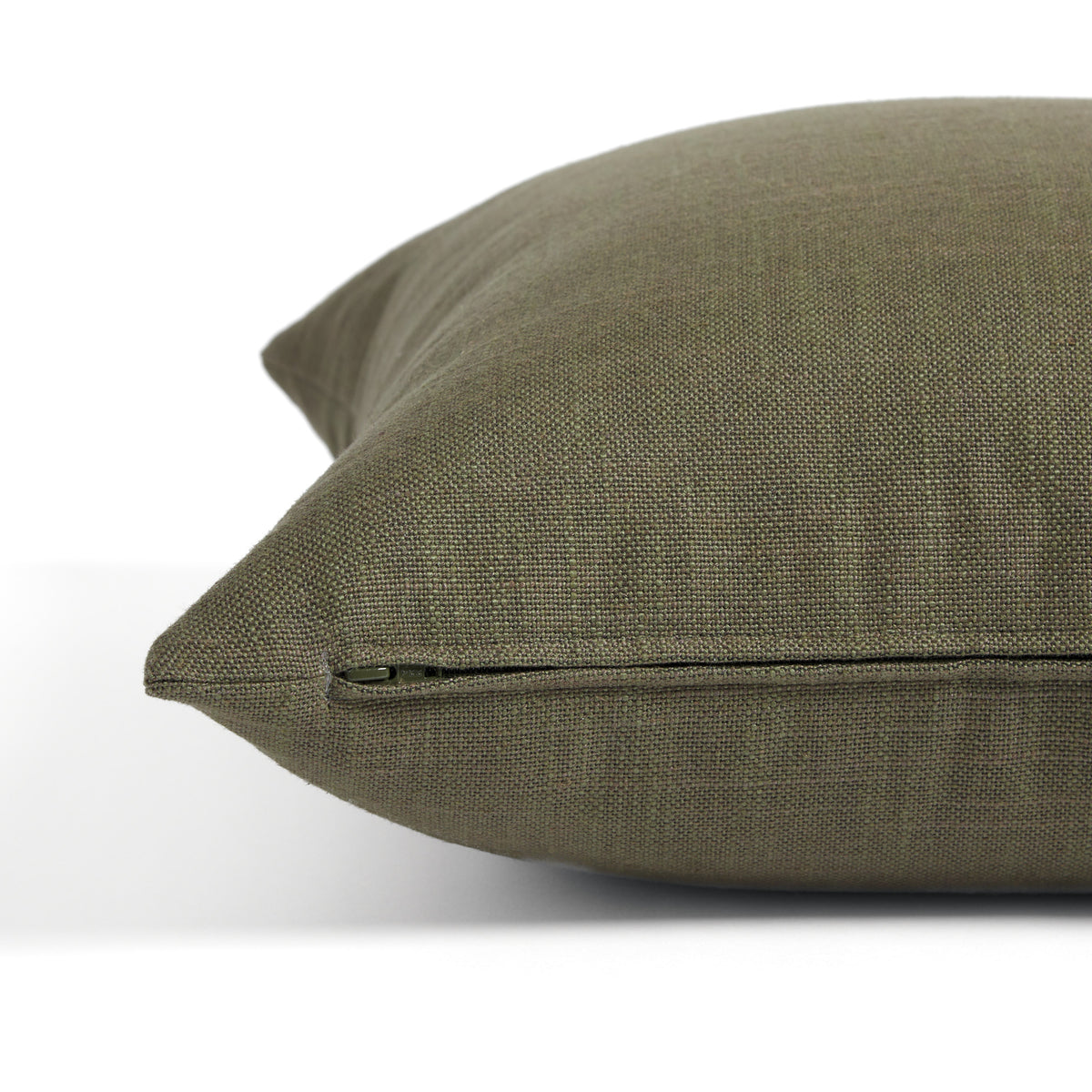 Side zipper detail of Tonic Living Hampton 22x22 pillow in moss green with a linen-inspired texture.