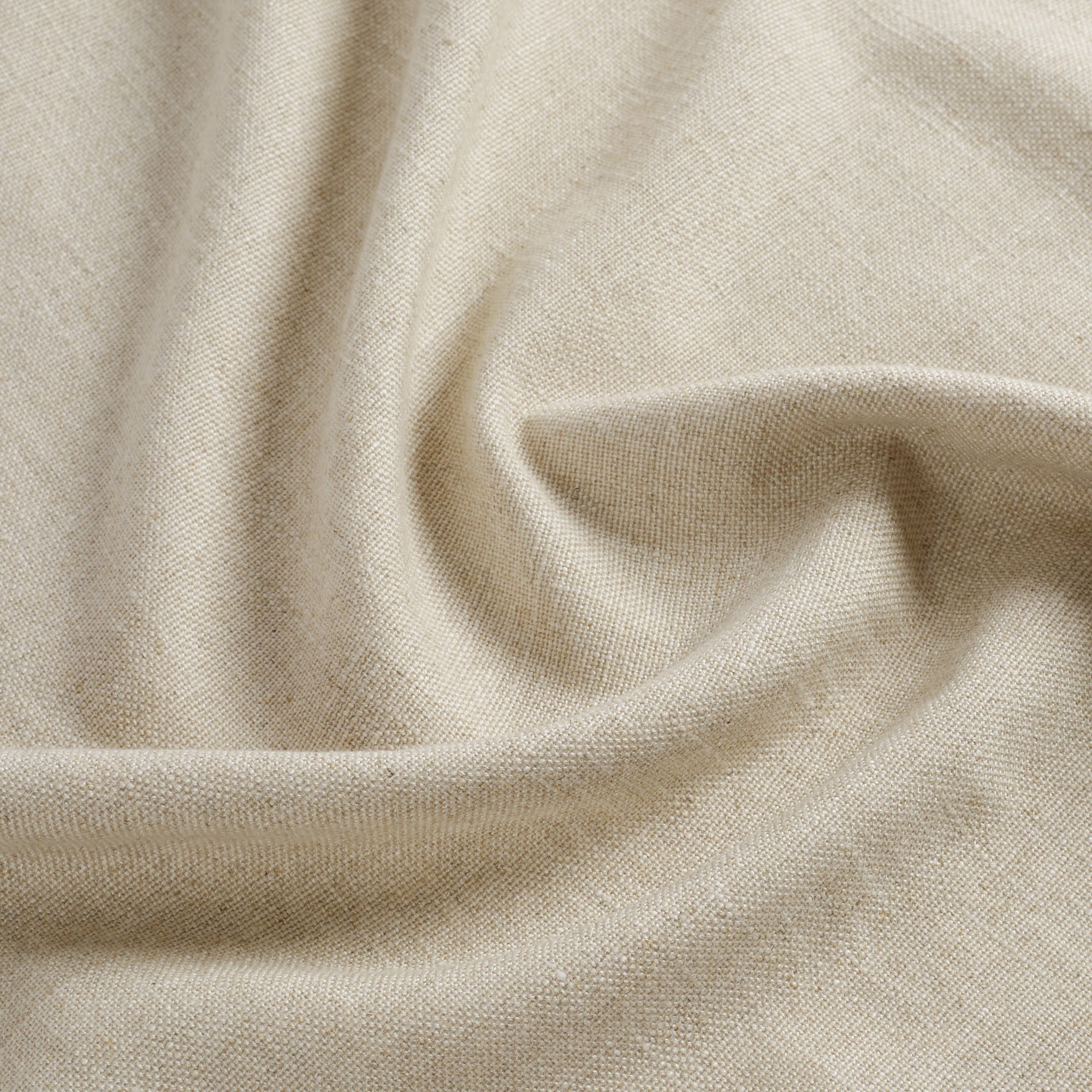Tonic Living Hampton Oatmeal performance fabric shown with movement highlighting its soft linen-like texture.