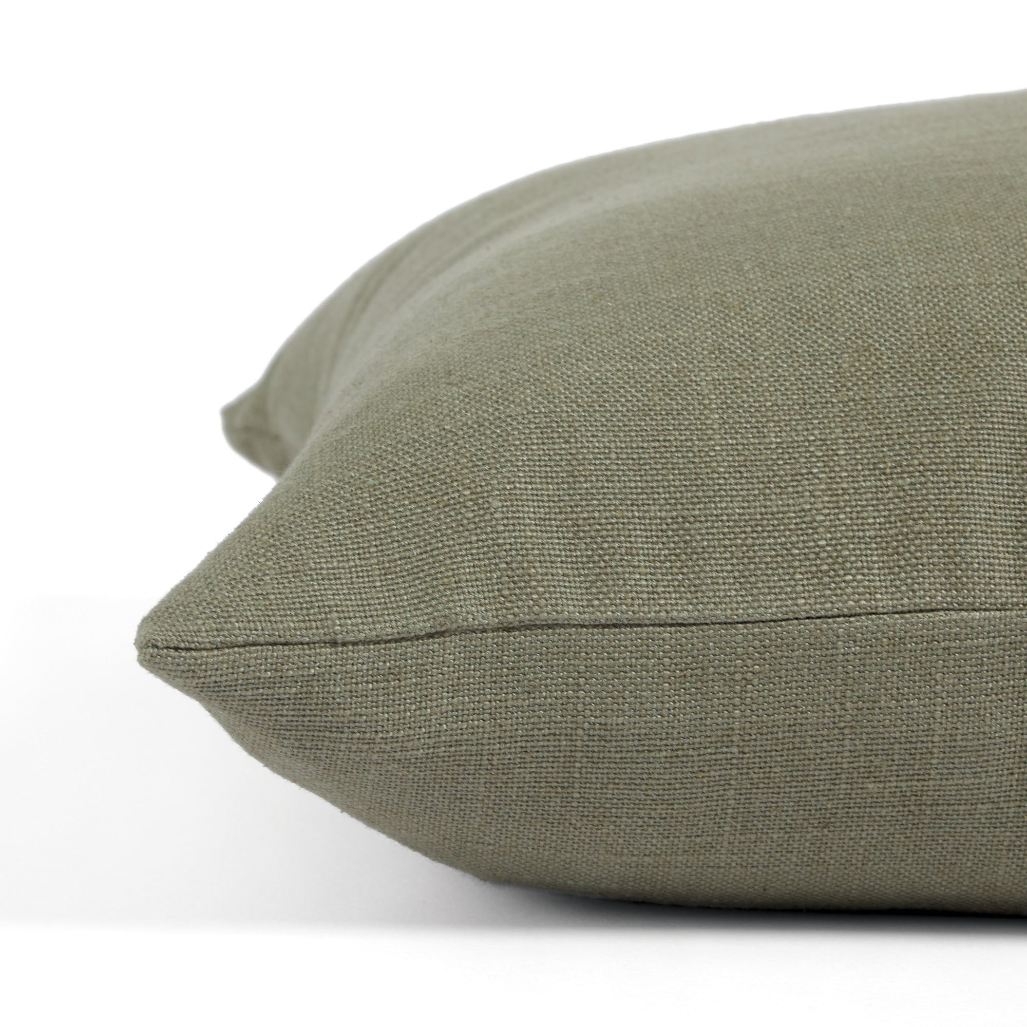 Side view of Tonic Living Hampton Sage decorative pillow highlighting its earthy green Belgian linen look.