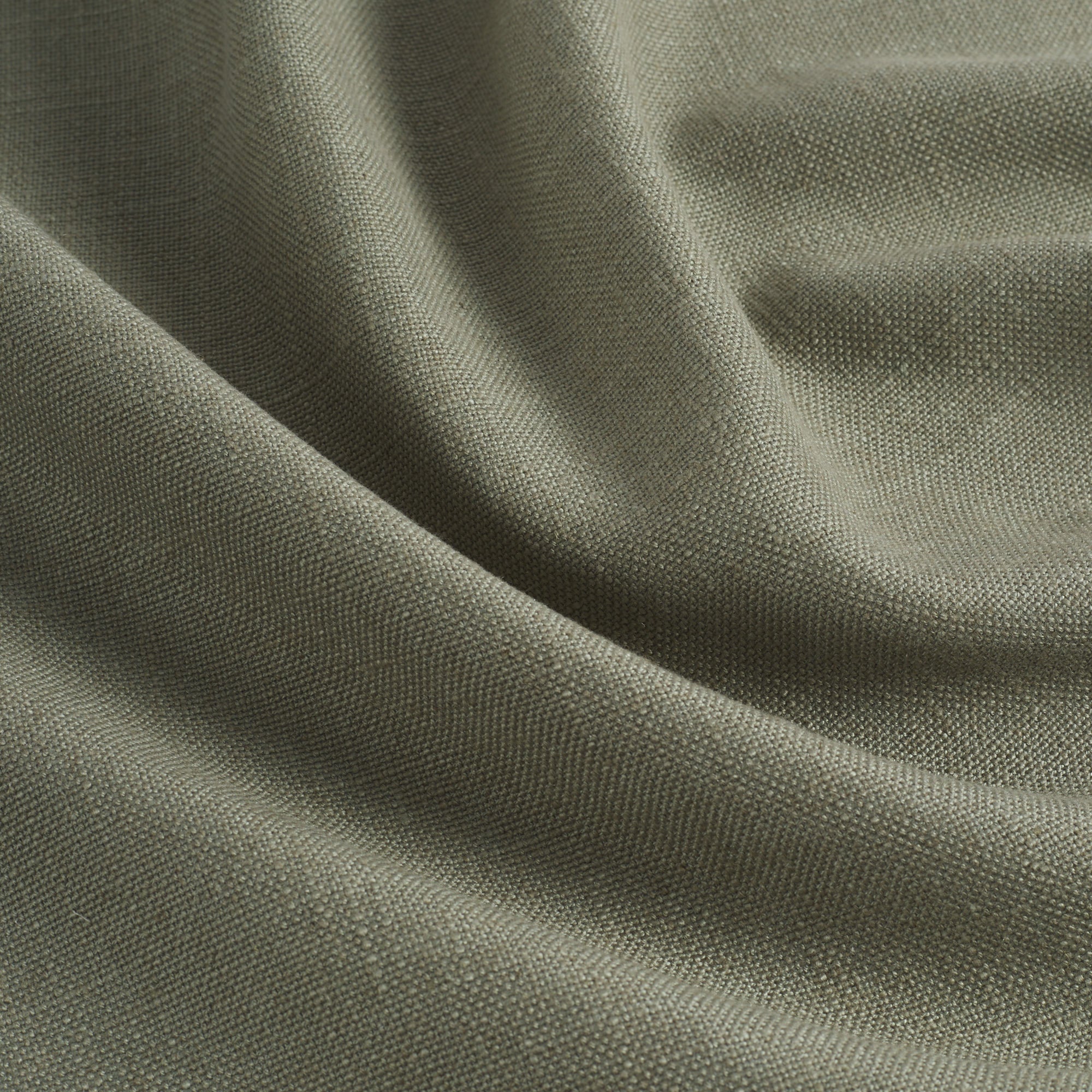 Tonic Living Hampton Sage performance fabric shown with movement highlighting its soft linen-like texture.