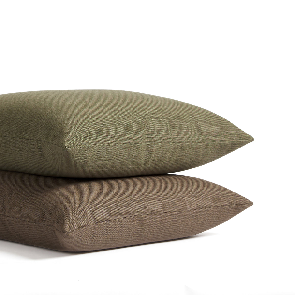 Stack of Tonic Living Hampton pillows in Walnut dark brown and Moss earthy green with linen-inspired texture.