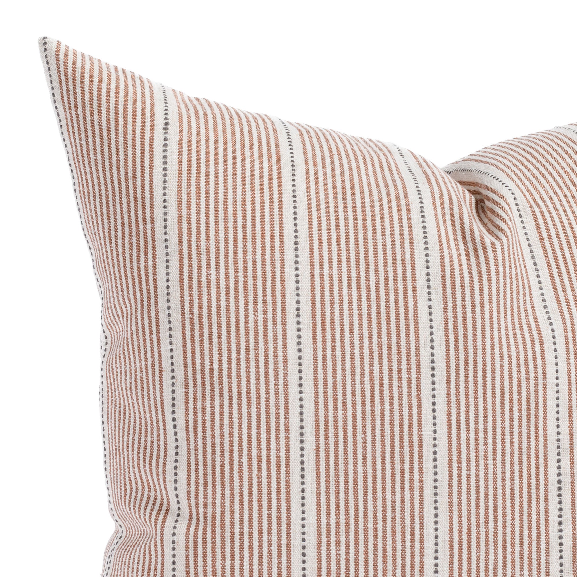 a rust red, cream and black pillow: close up view