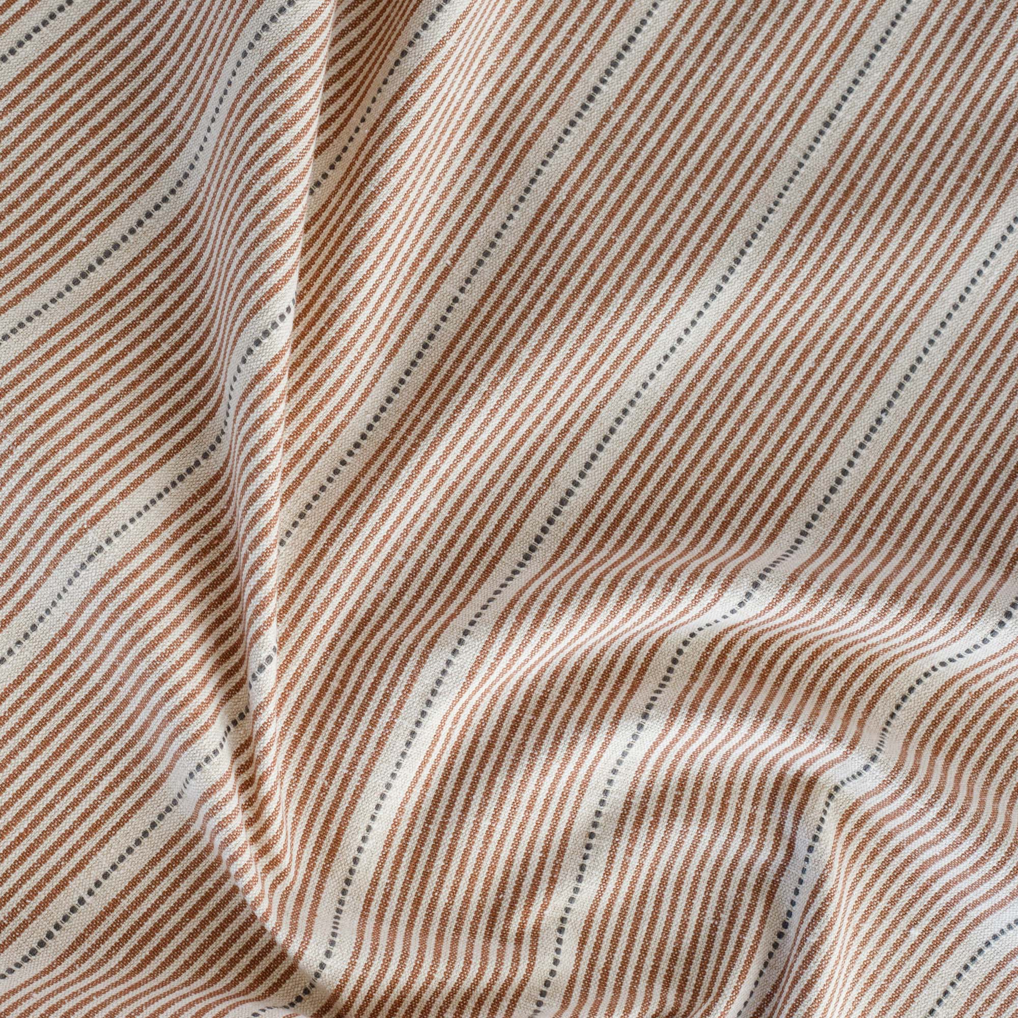 a rust red, parchment and black stripe multi use fabric
