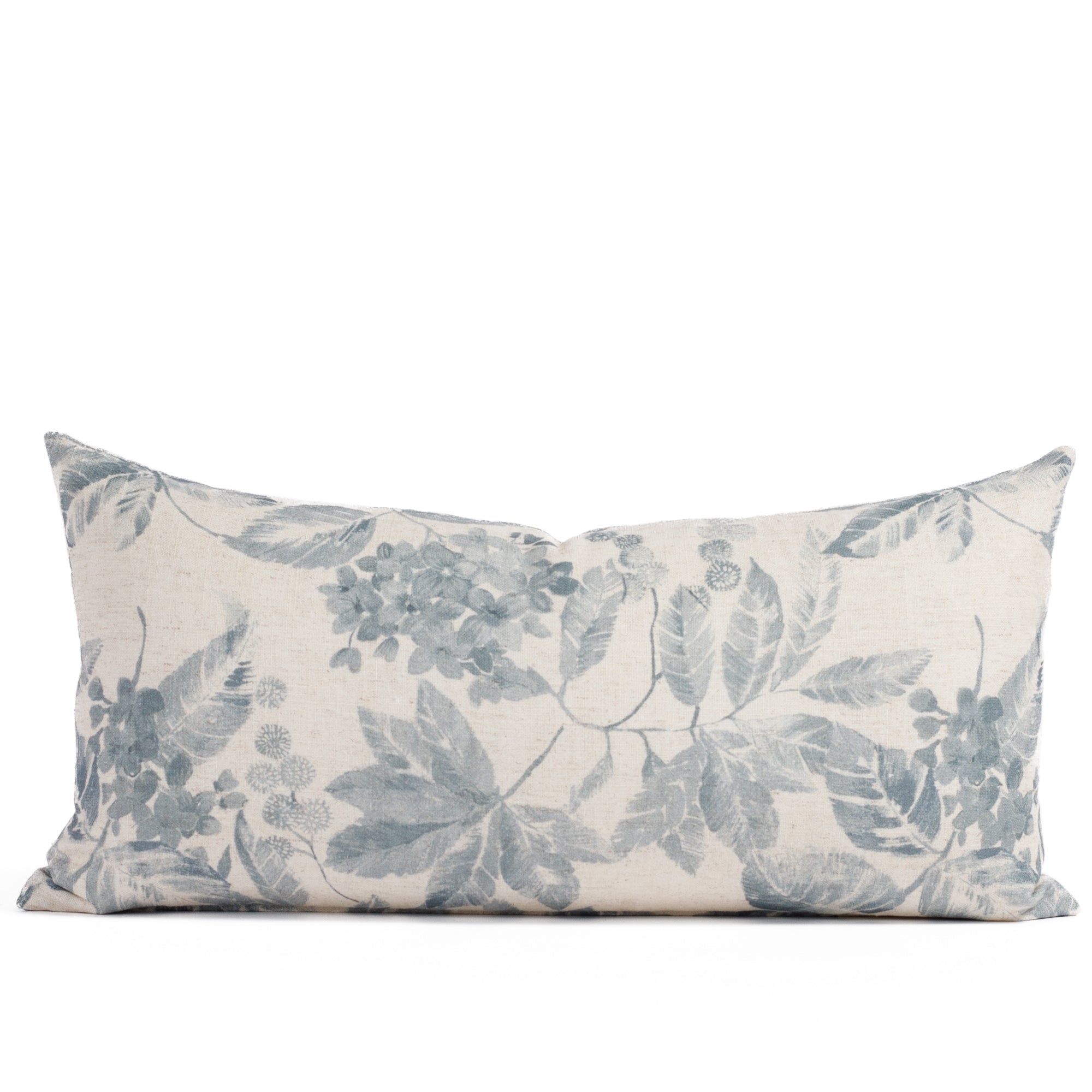 Front view of Tonic Living’s Heather Indigo 12x24 lumbar toss pillow, featuring vintage hydrangea blooms in a soft indigo blue and oatmeal beige palette on a linen-blend fabric.