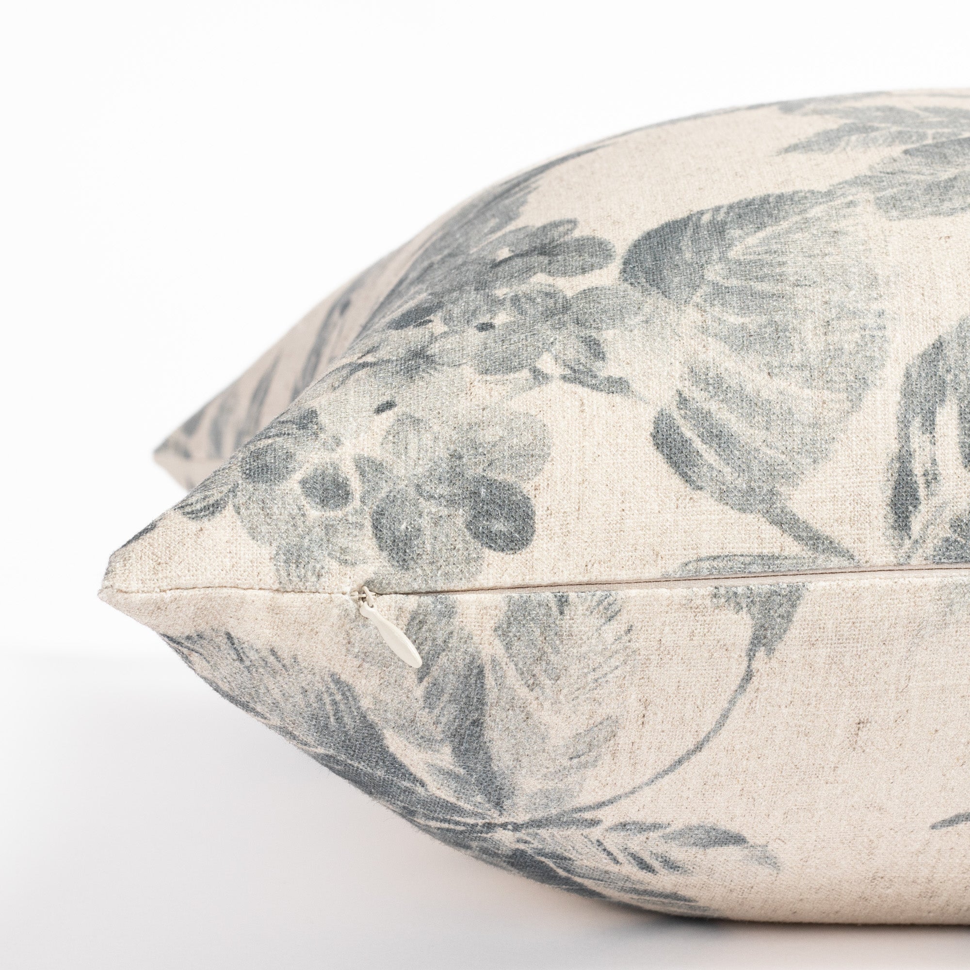 an indigo blue and oatmeal vintage floral print pillow : close up zipper view