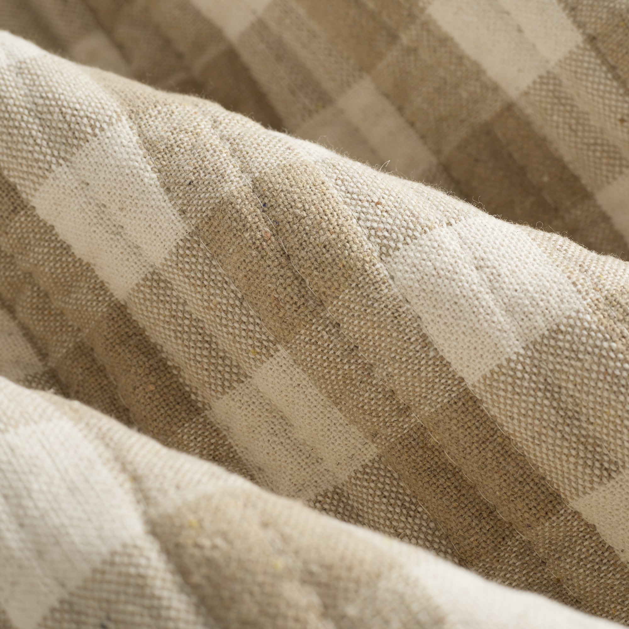 Close up of Tonic Living Henry Check Wheat fabric showing quilted texture and off-white and beige gingham detail.