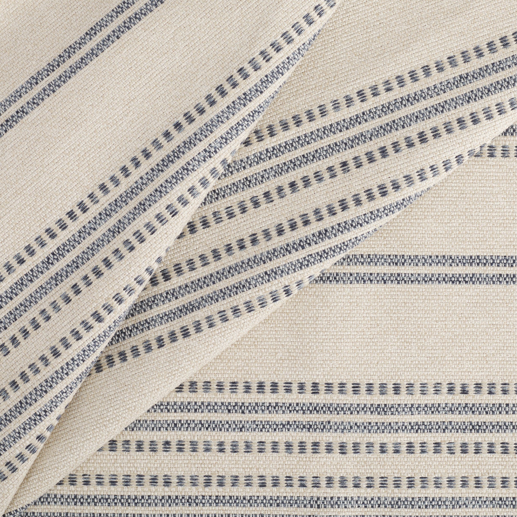 Tonic Living Hopper Stripe Denim upholstery fabric featuring blue striped pattern on a beige-tan background.