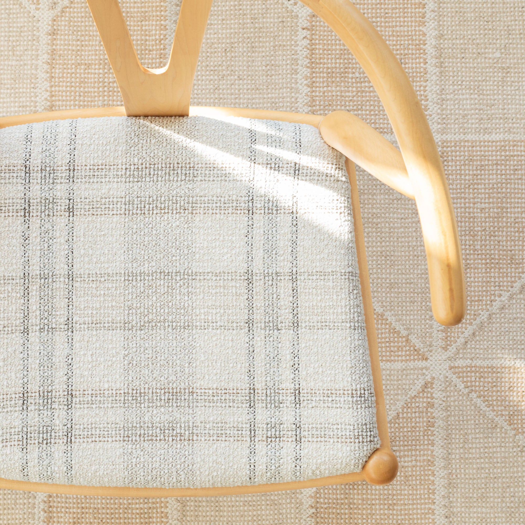 a cream, brown and grey high performance plaid patterned upholstered chair seat