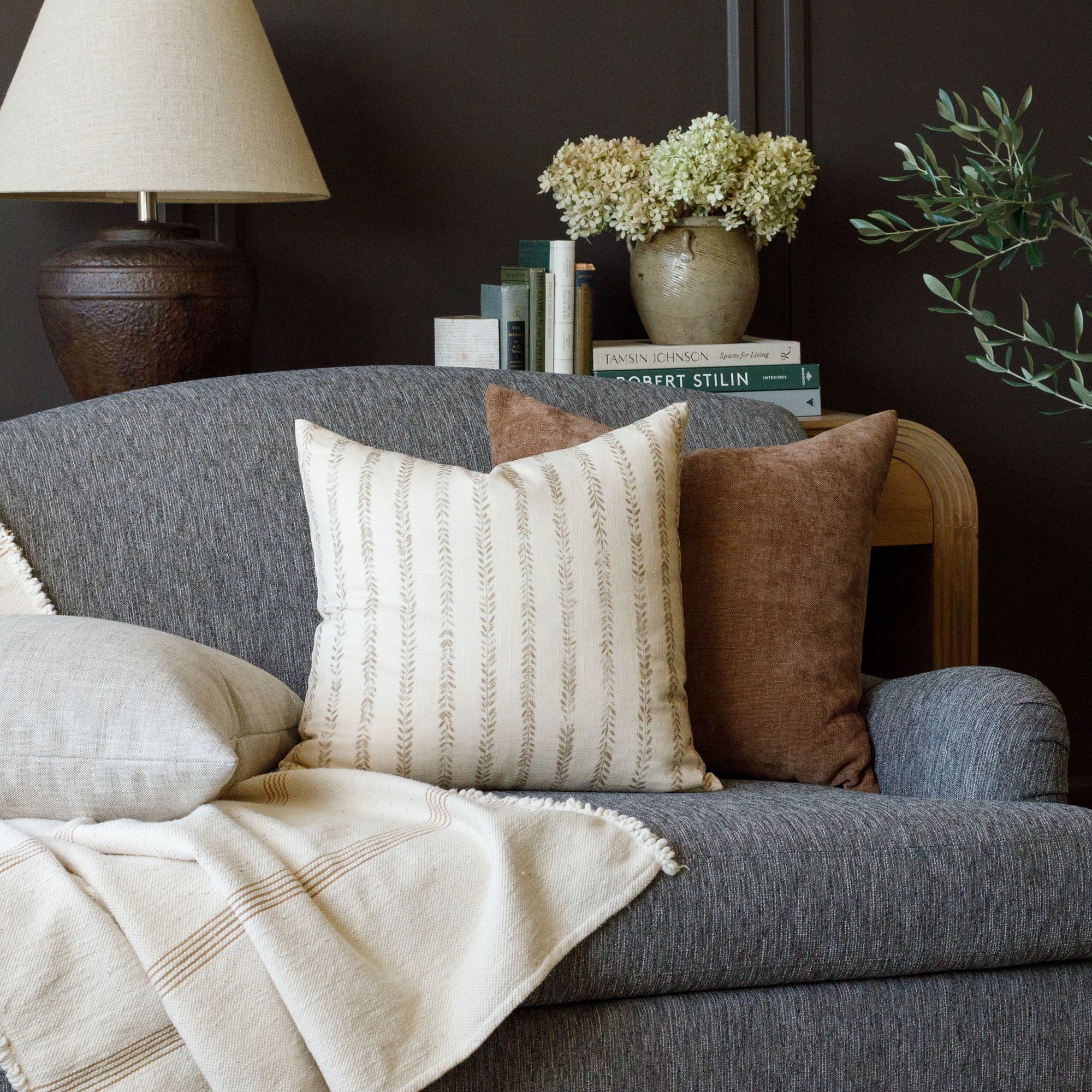 earth toned pillow pairing : Ivy Chestnut and Blaine Cinnamon on a Porter Sable sofa