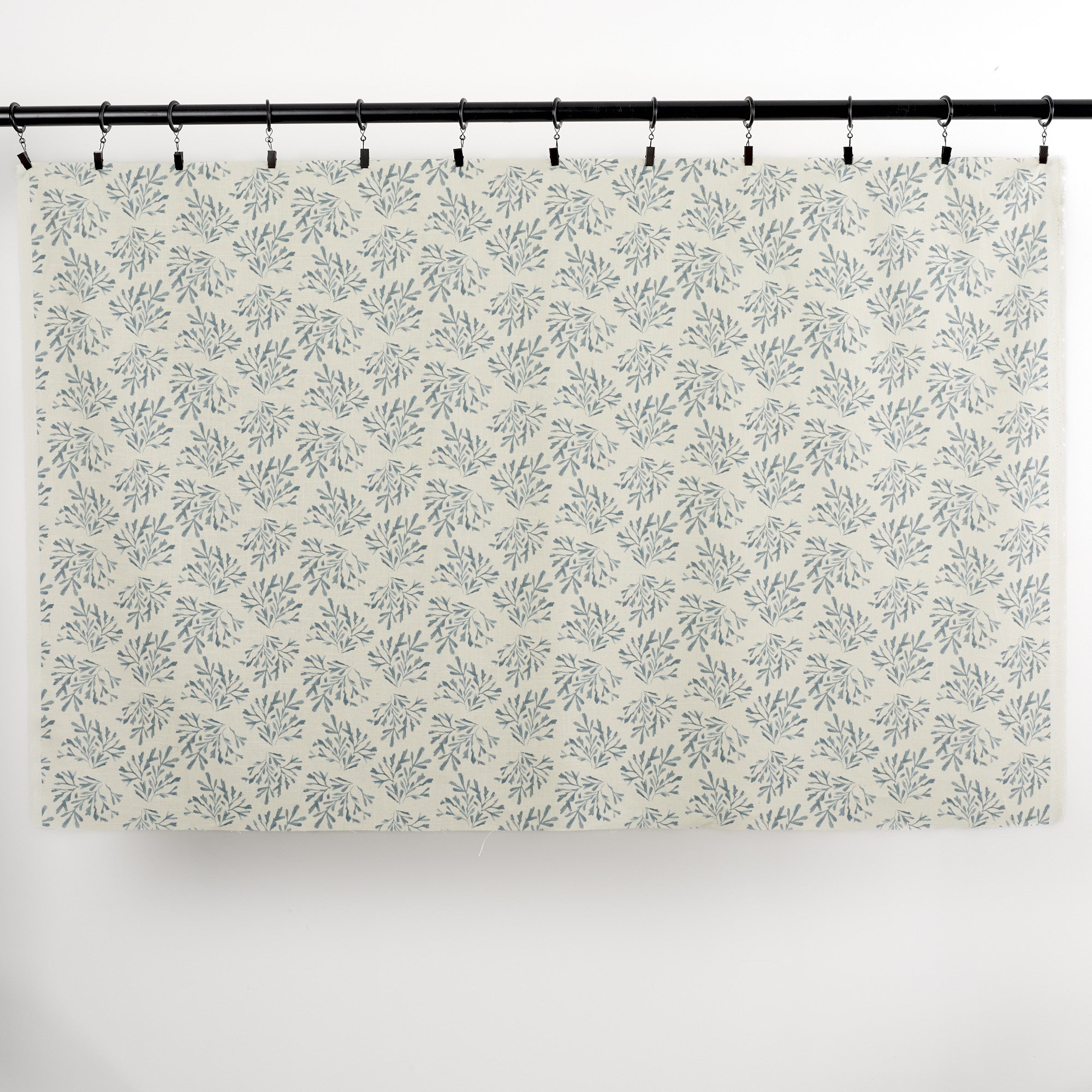 Full yard of Tonic Living Juniper Harbour Blue curtain fabric showing blue botanical print on cream ground.