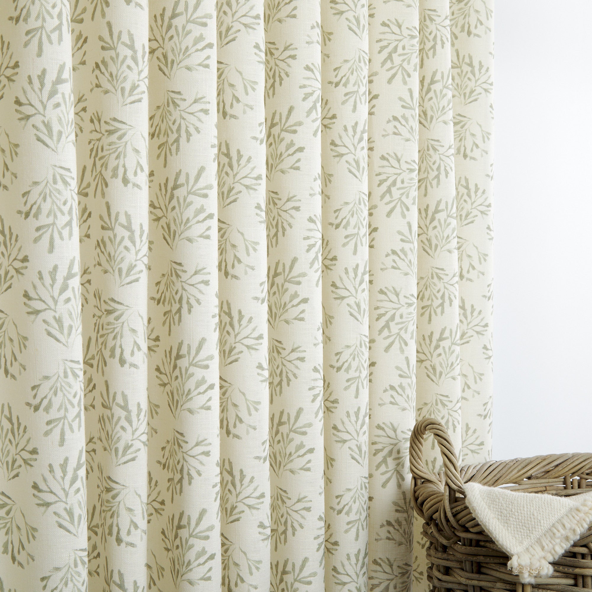 Tonic Living Juniper Sage drapery fabric with botanical print shown as sage green and cream curtains.