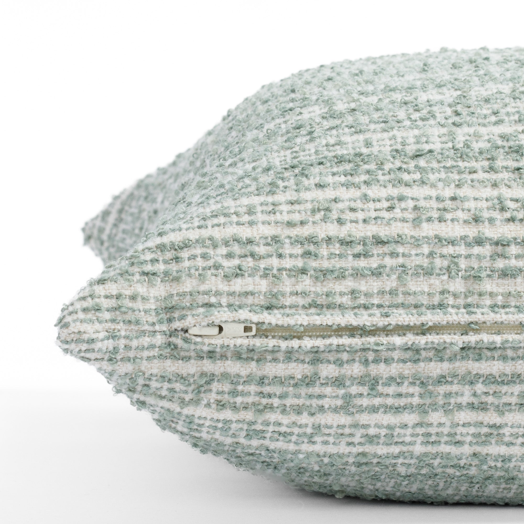 a cream and blue green boucle stripe throw pillow : close up zipper view